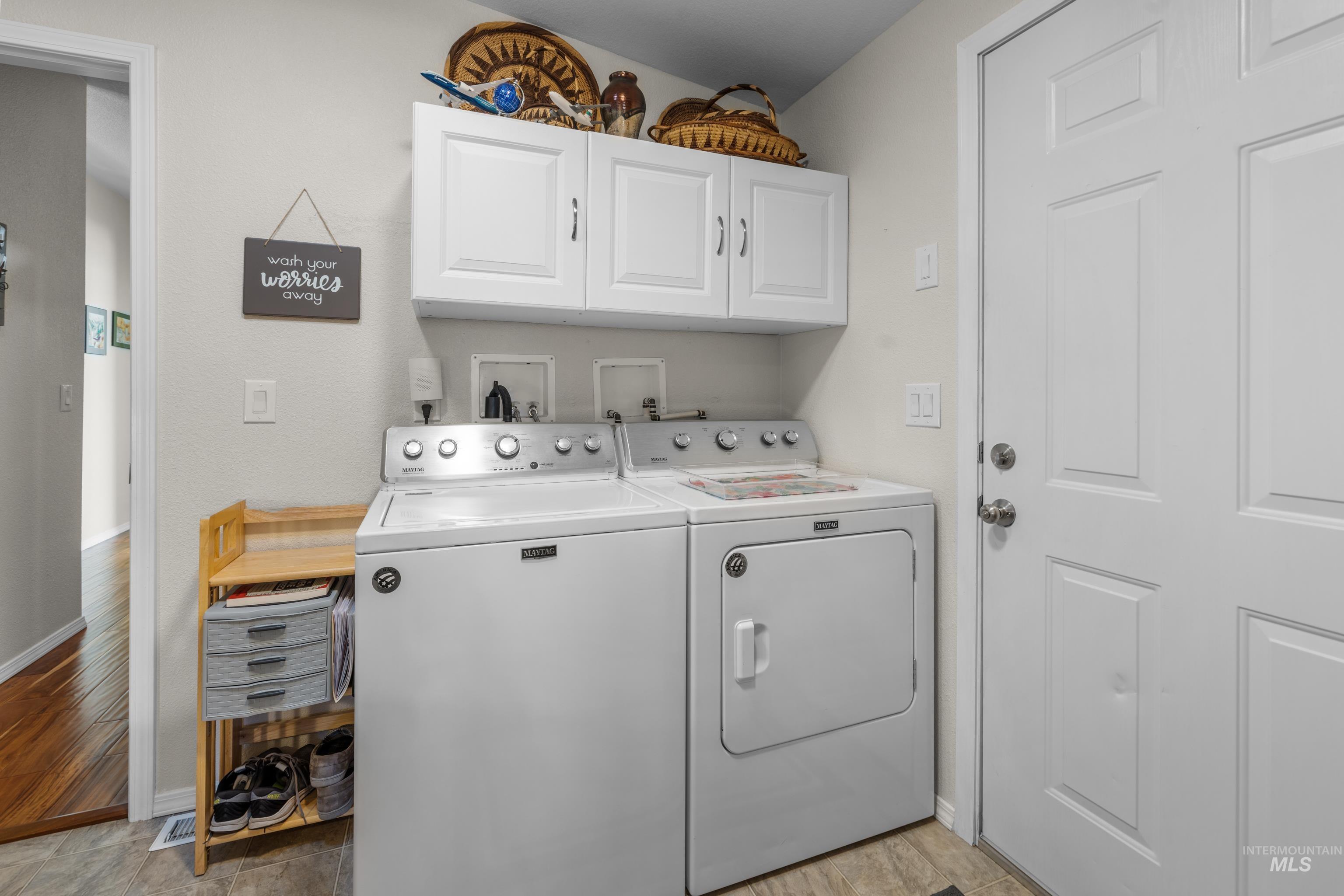 Laundry room featuring cabinet space and washing machine and dryer