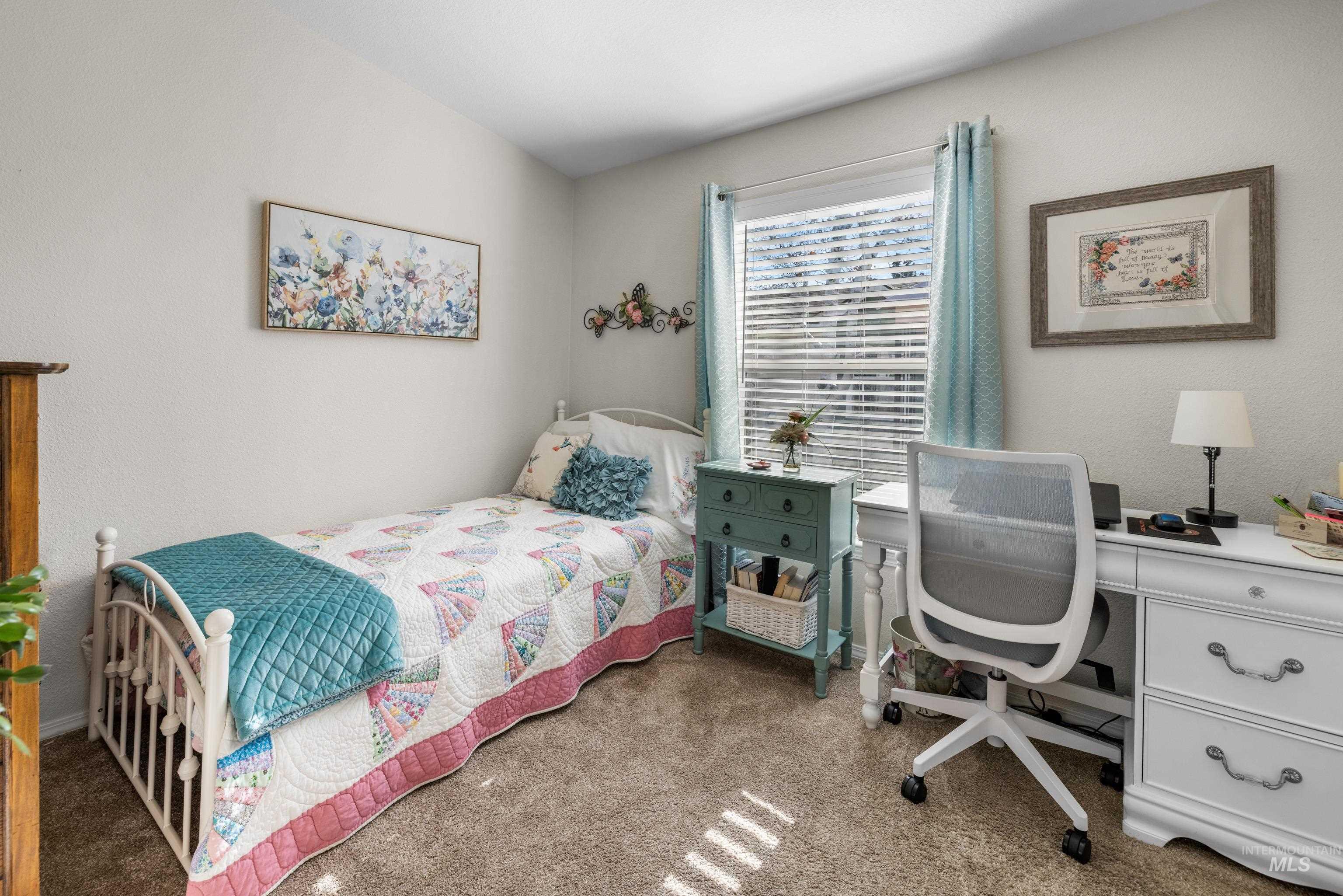 Carpeted bedroom featuring an office area