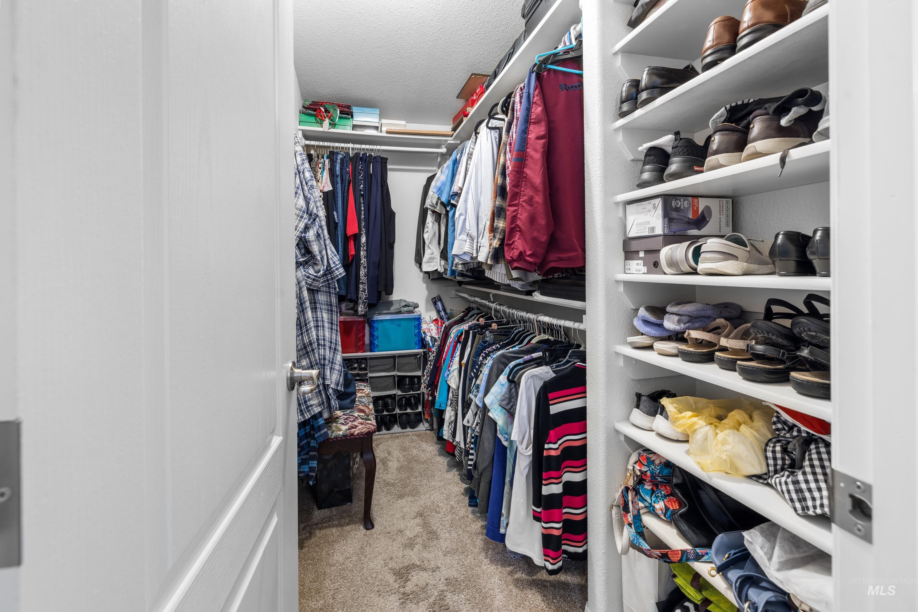 Walk in closet featuring light carpet