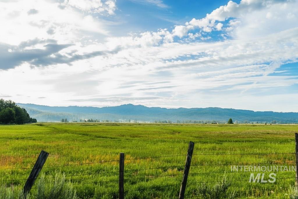 View of mountain backdrop featuring a pastoral area and rural landscape