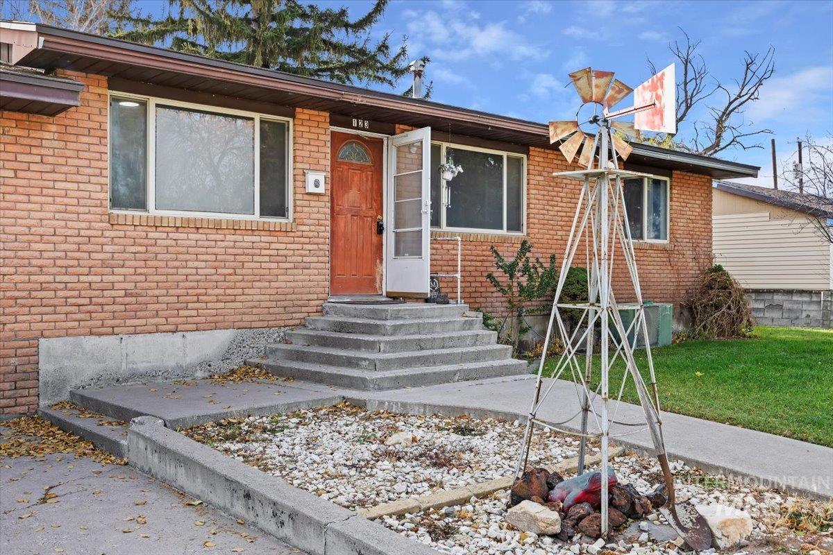 View of front of home featuring brick siding