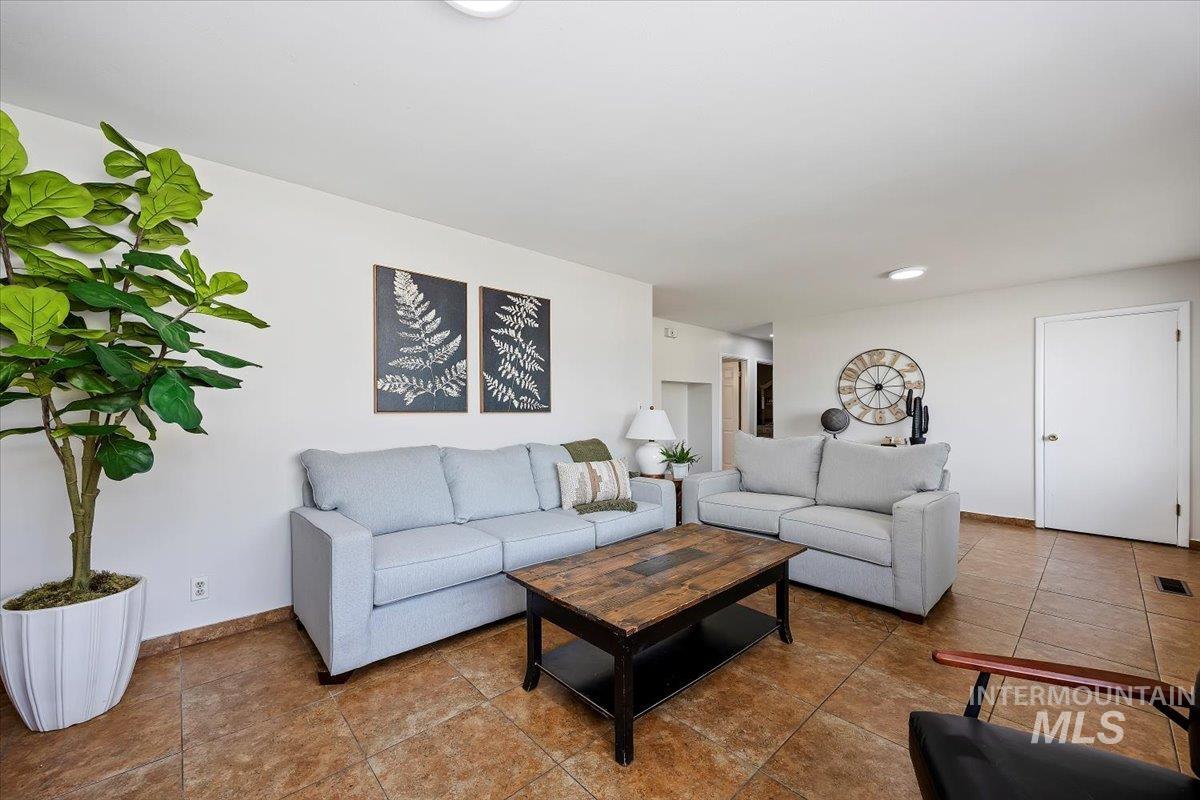 Living area with tile patterned flooring and recessed lighting