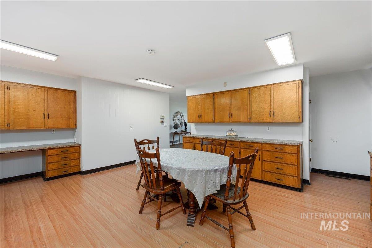 Dining room with built in desk and light wood-style floors
