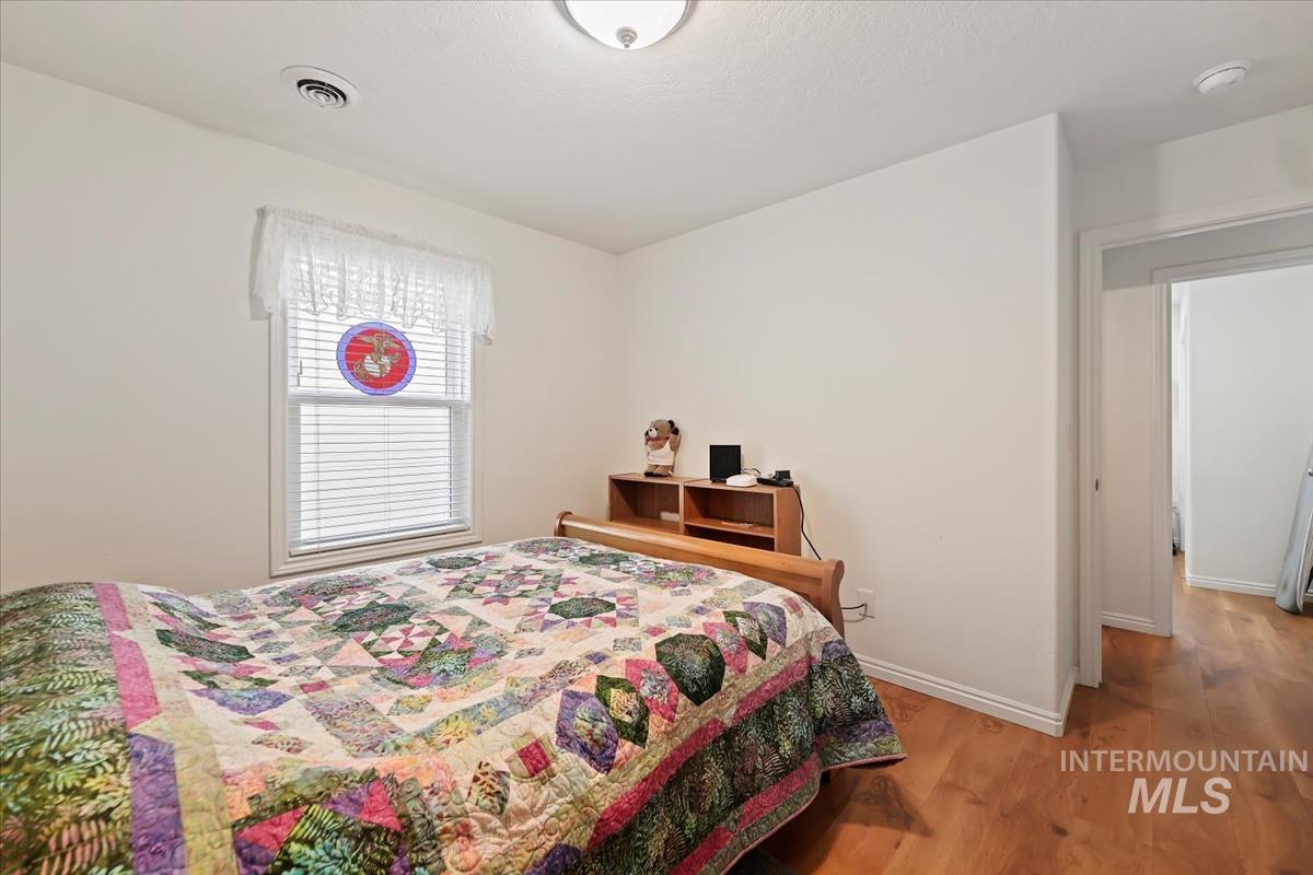 Bedroom with light wood-type flooring and baseboards