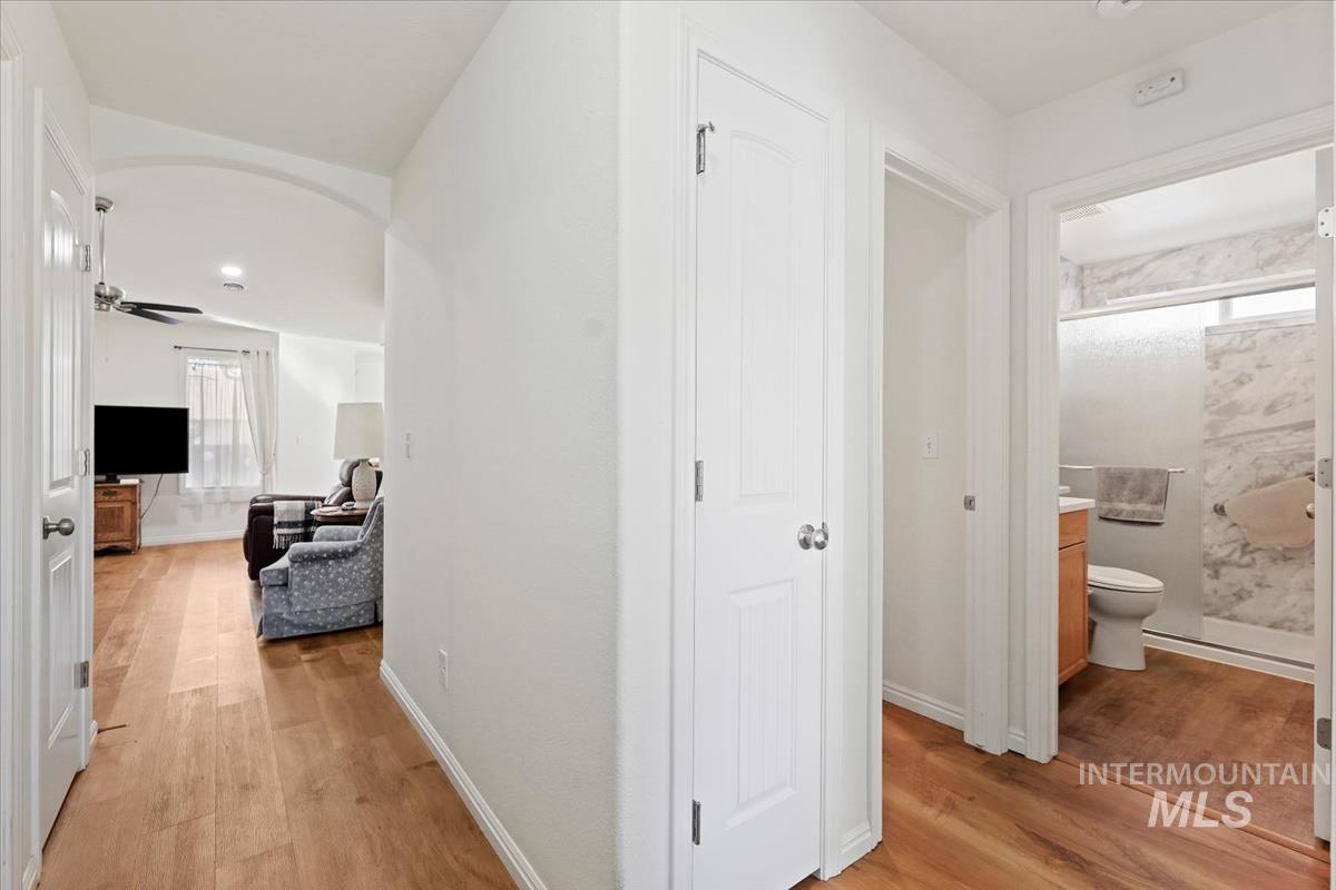 Hallway with light wood-style floors and baseboards