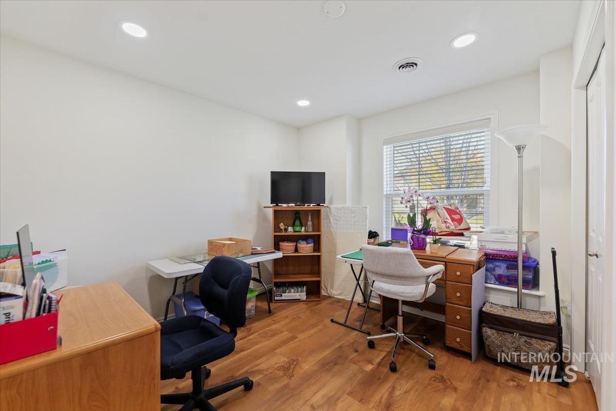 Home office featuring wood finished floors and recessed lighting