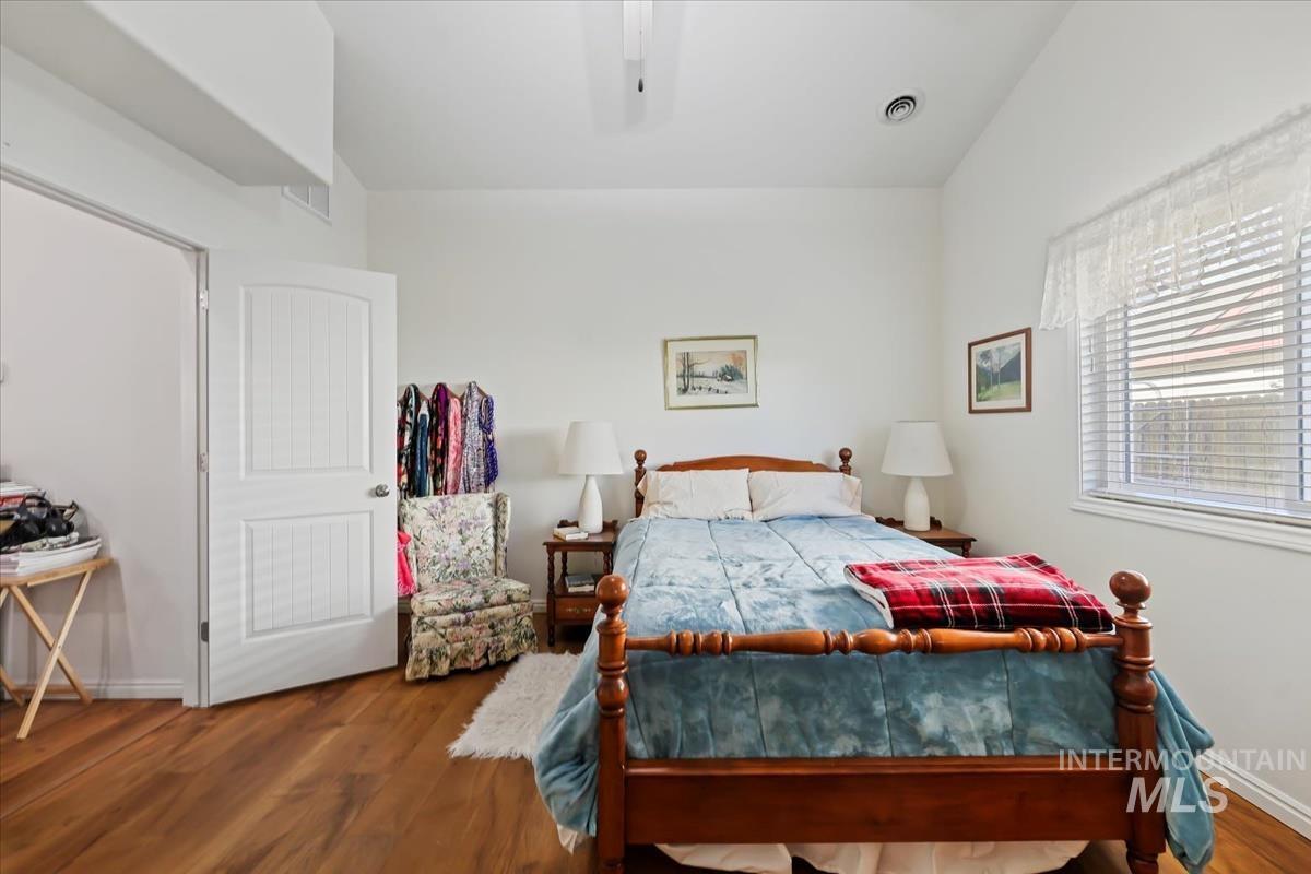Bedroom featuring wood finished floors and ceiling fan