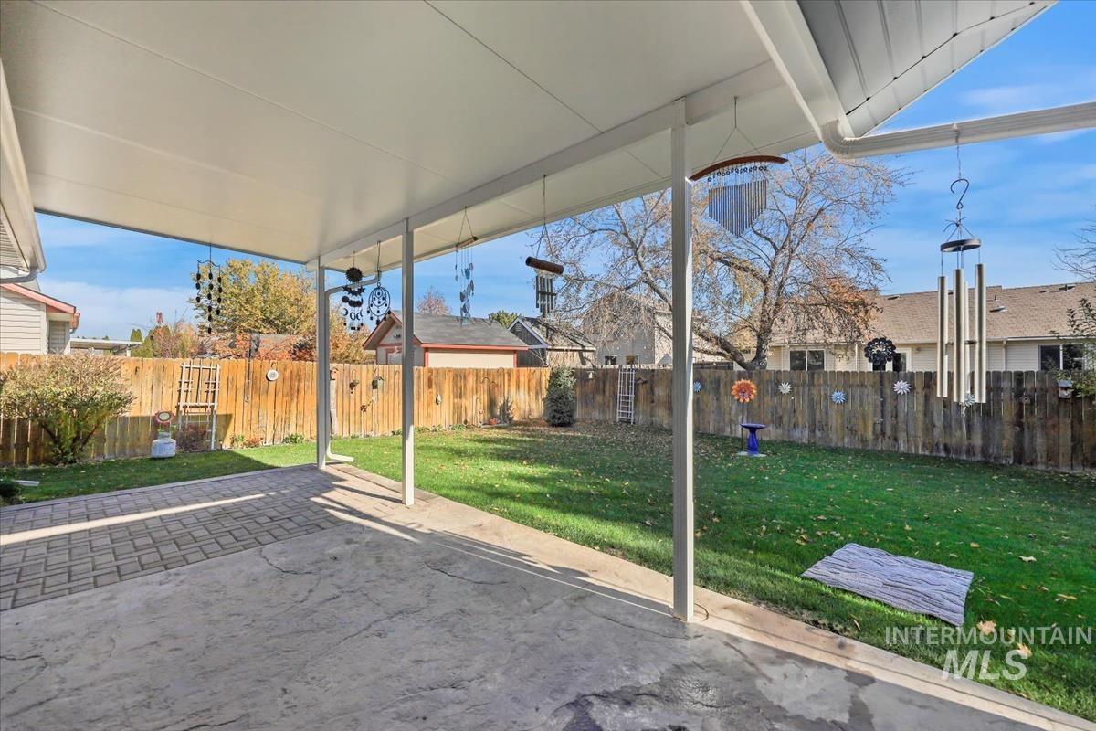 Fenced backyard with a patio area