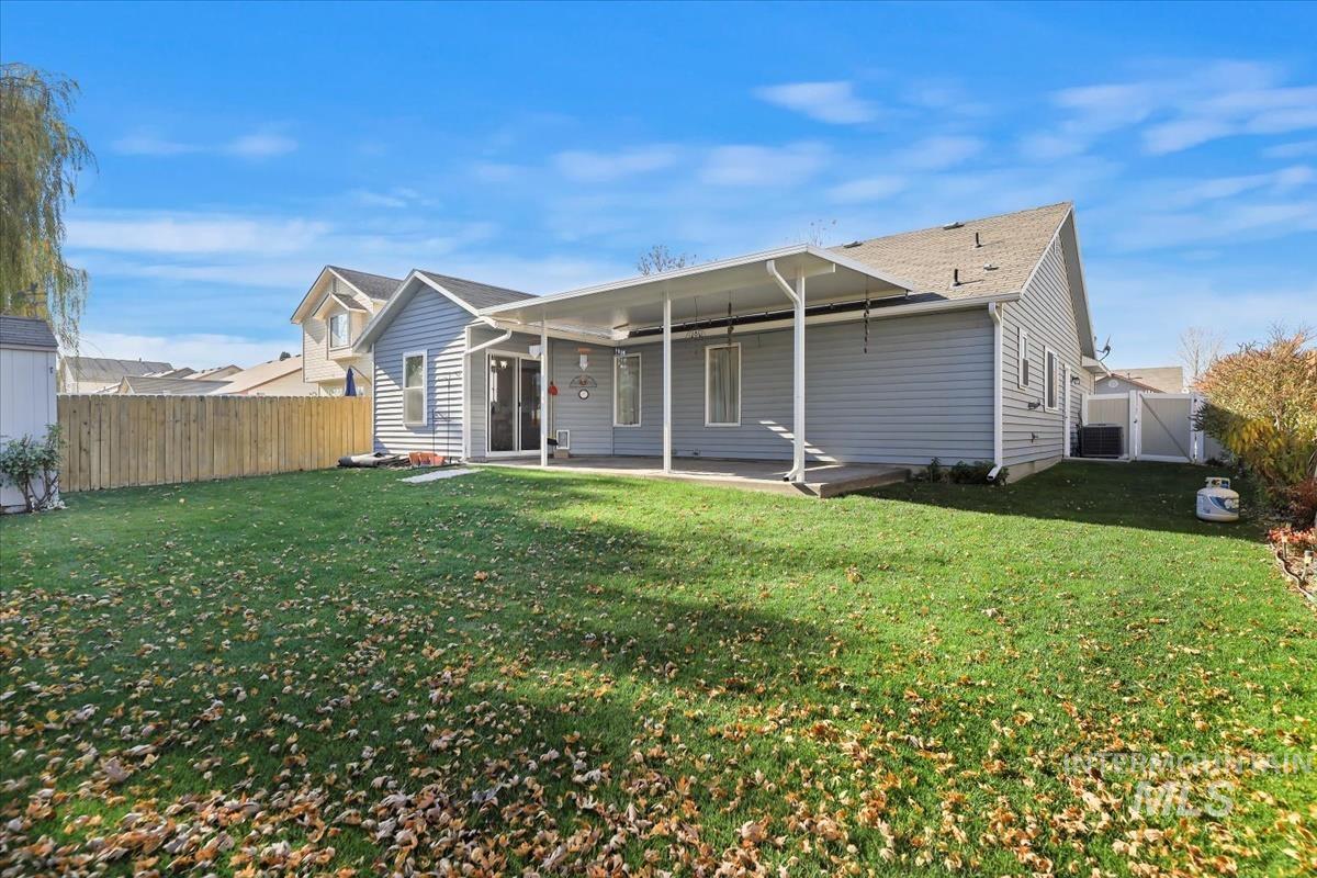 Back of house featuring a patio area, a fenced backyard, and a shingled roof
