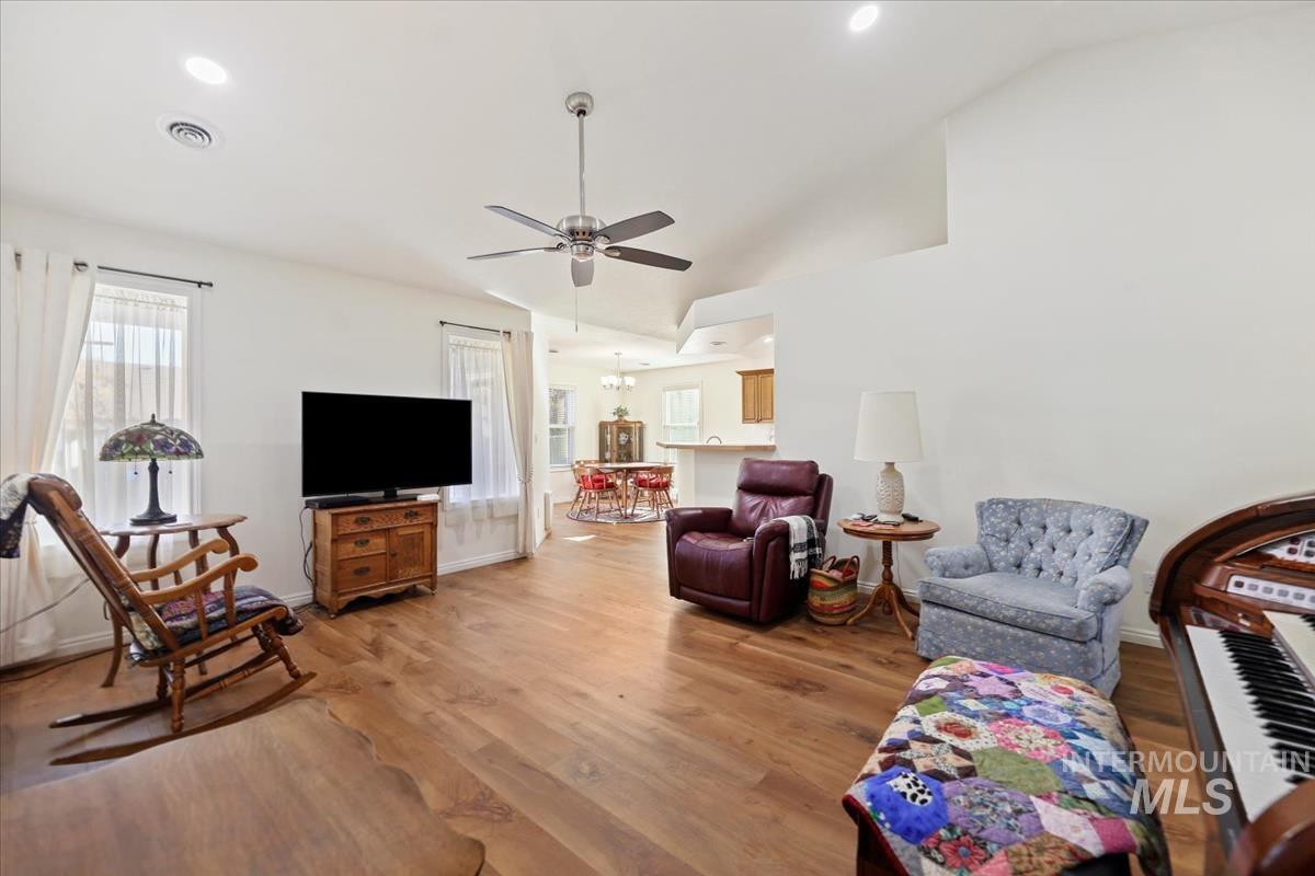 Living room featuring ceiling fan, wood finished floors, and recessed lighting