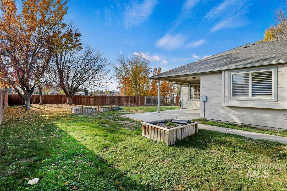 Fenced backyard with a patio