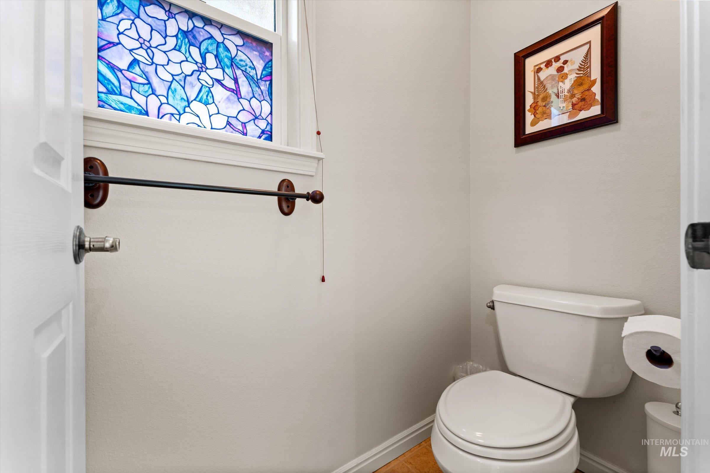 Bathroom featuring toilet and baseboards