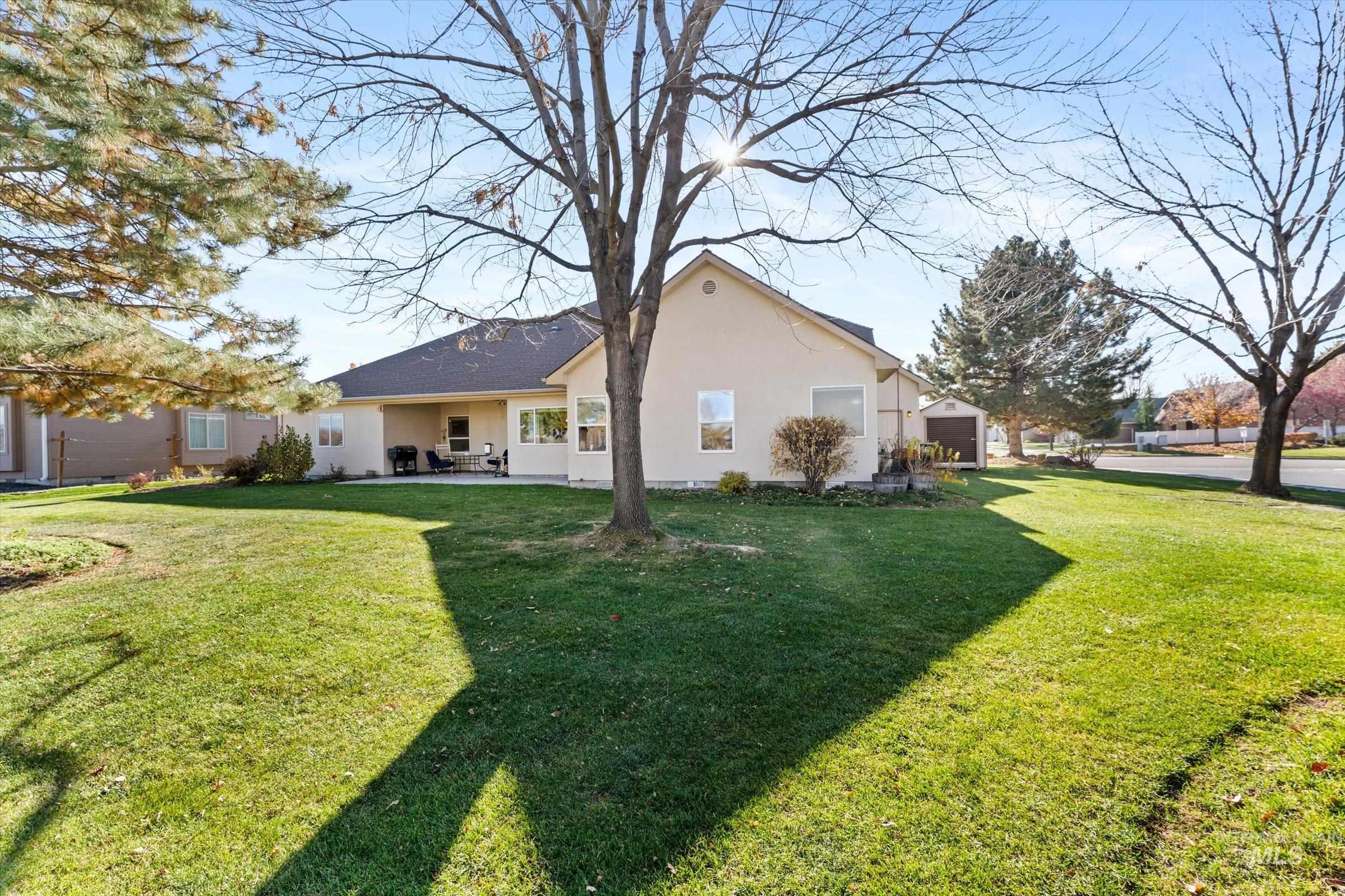 Back of property featuring stucco siding, a yard, and a patio area