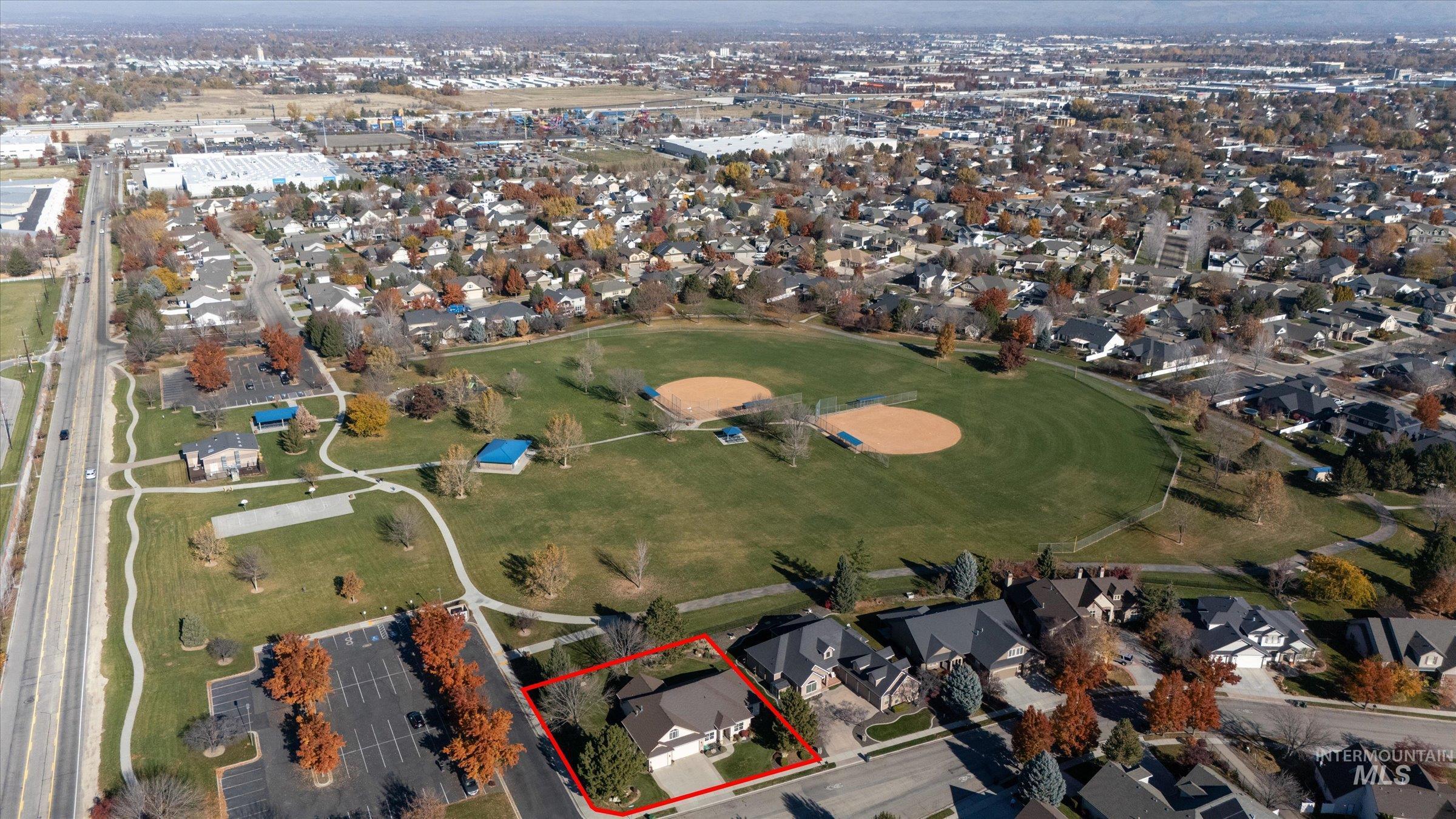 Aerial view of property and surrounding area with nearby suburban area