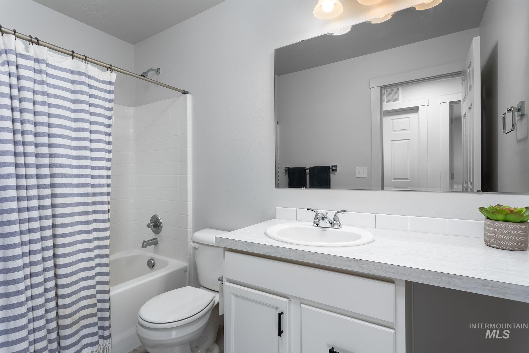 Bathroom featuring vanity and shower / tub combo