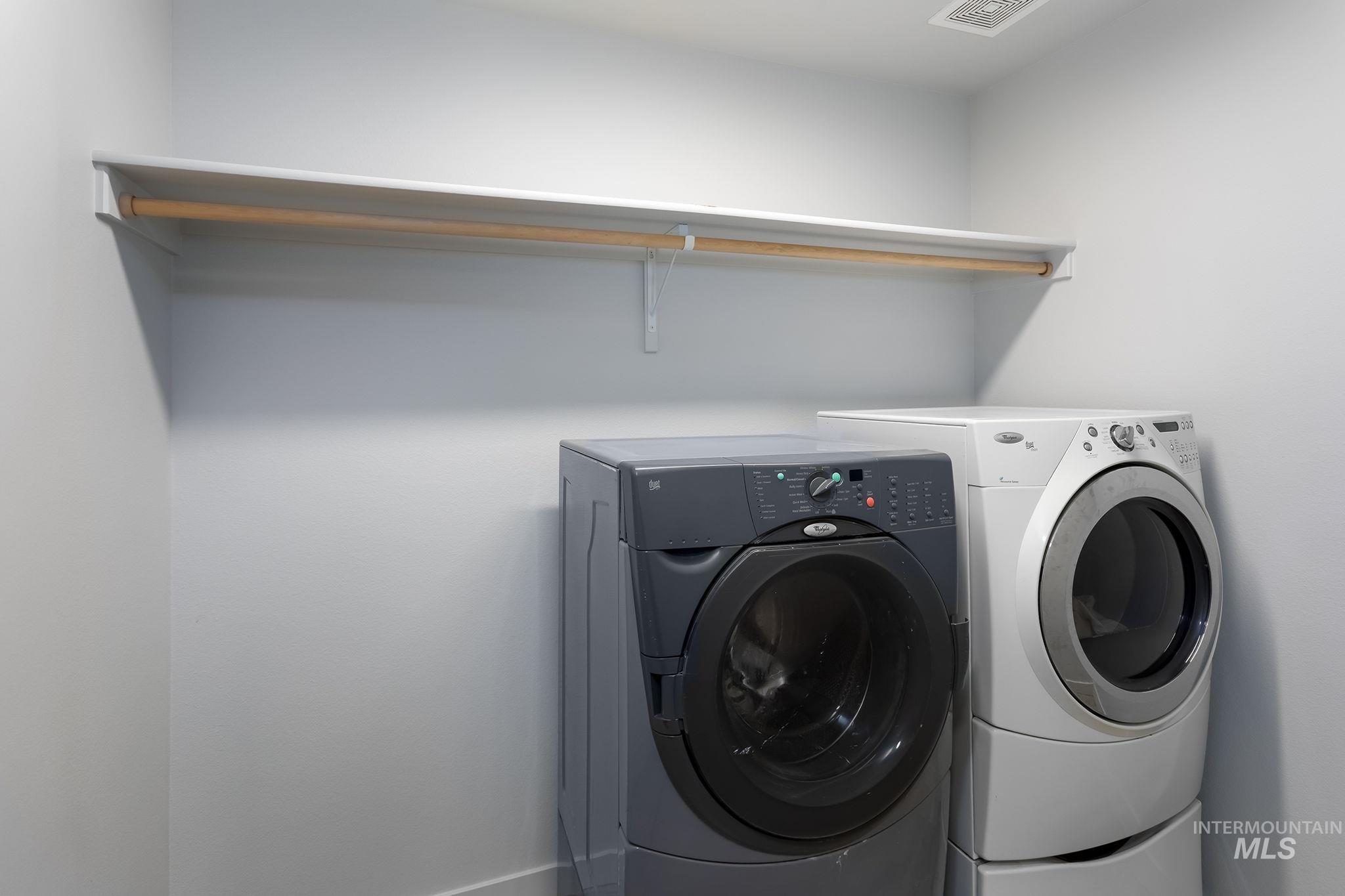 Laundry area featuring washer and clothes dryer and baseboards