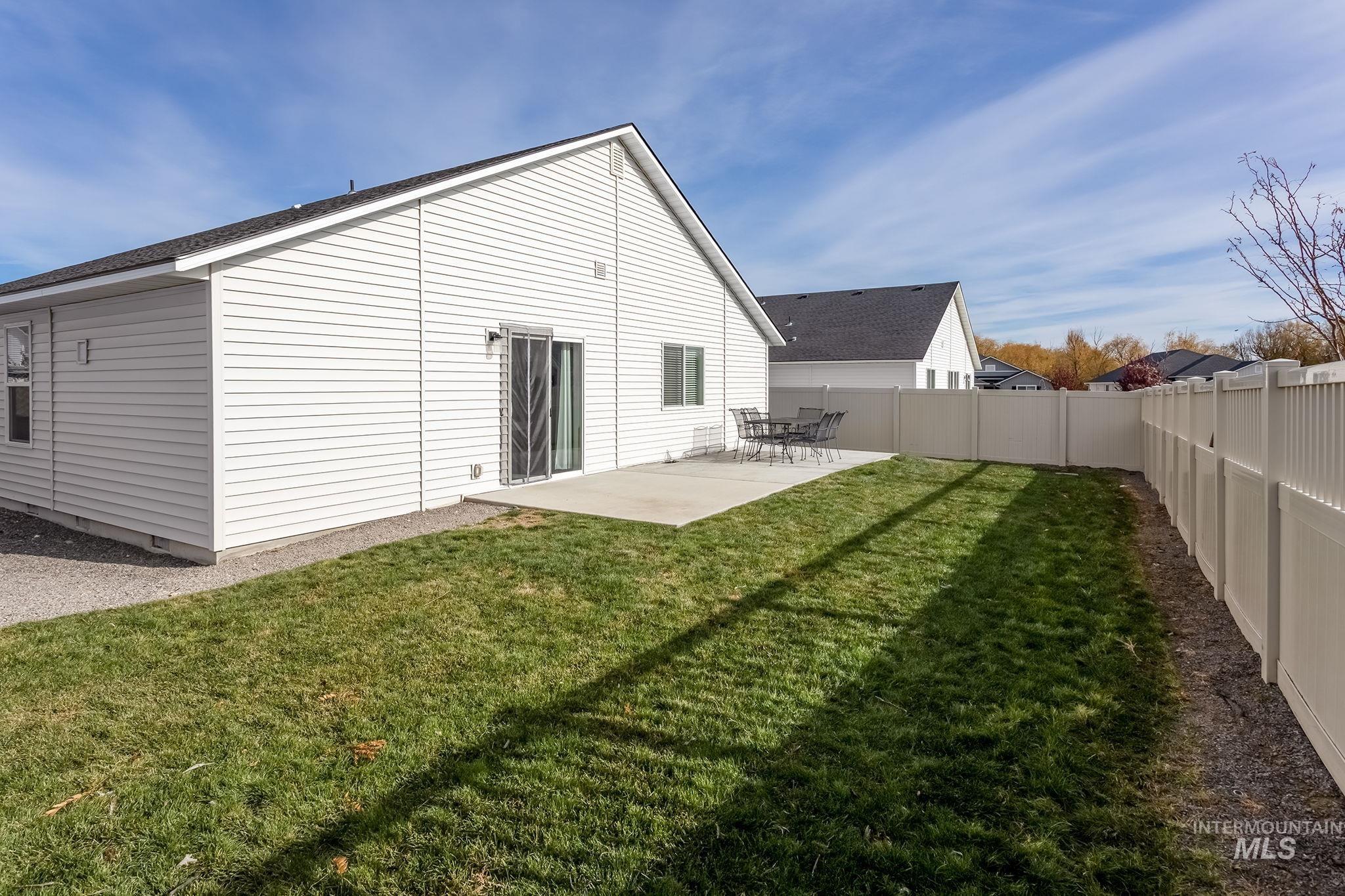 Back of house with a patio and a fenced backyard