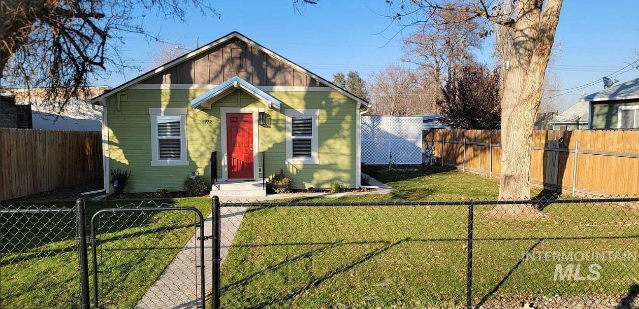 Bungalow-style house with a gate and a fenced front yard
