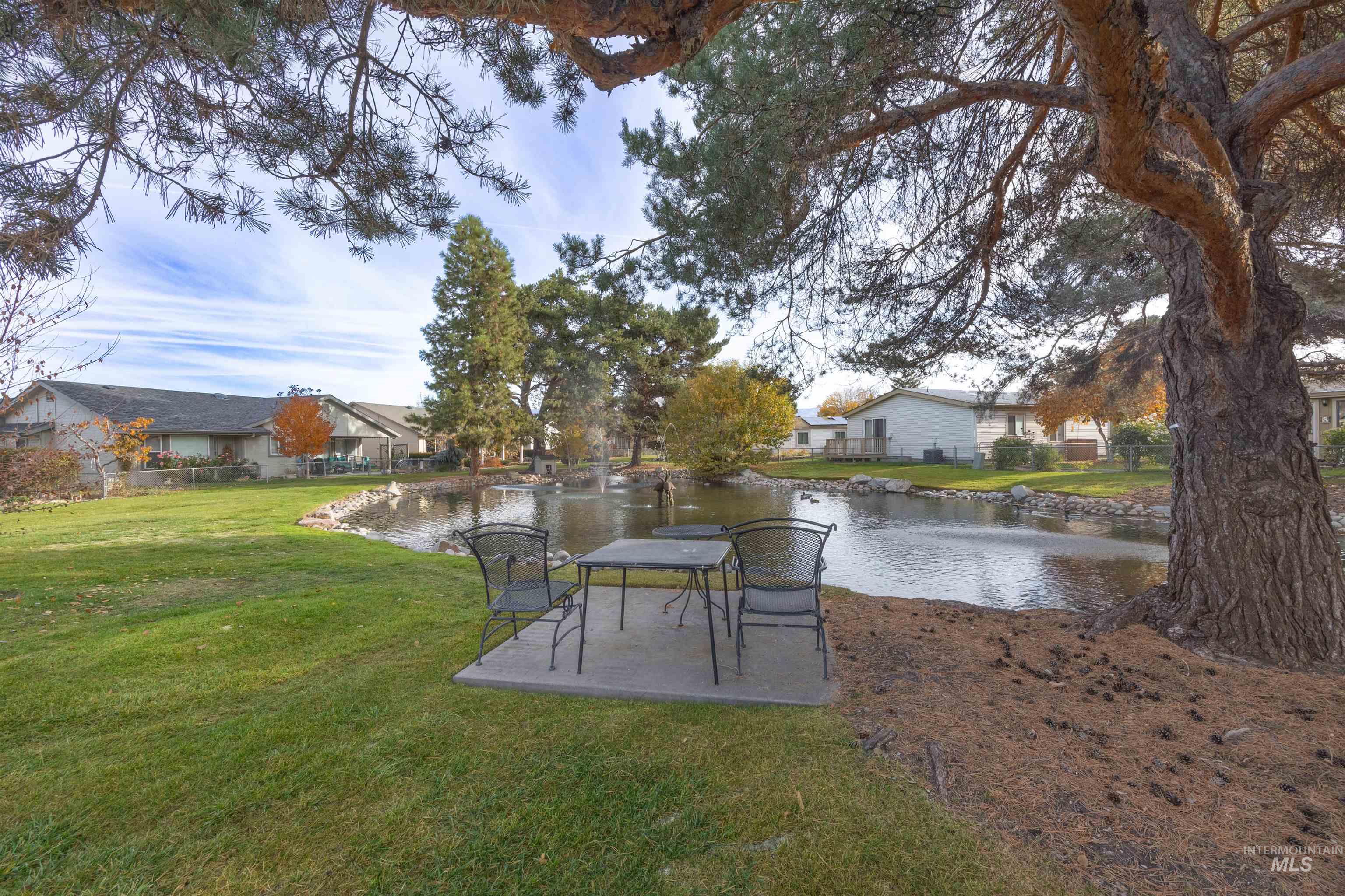 View of grassy yard featuring a water view and a residential view