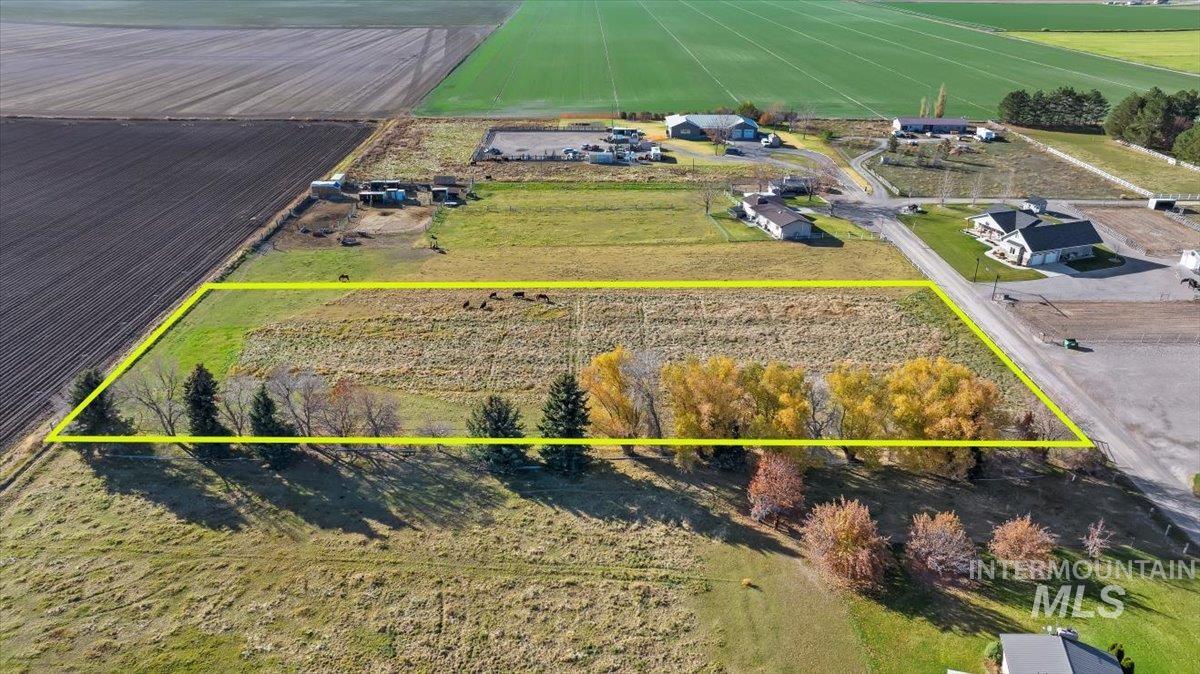 Aerial view of sparsely populated area with property boundaries highlighted and rows of crops