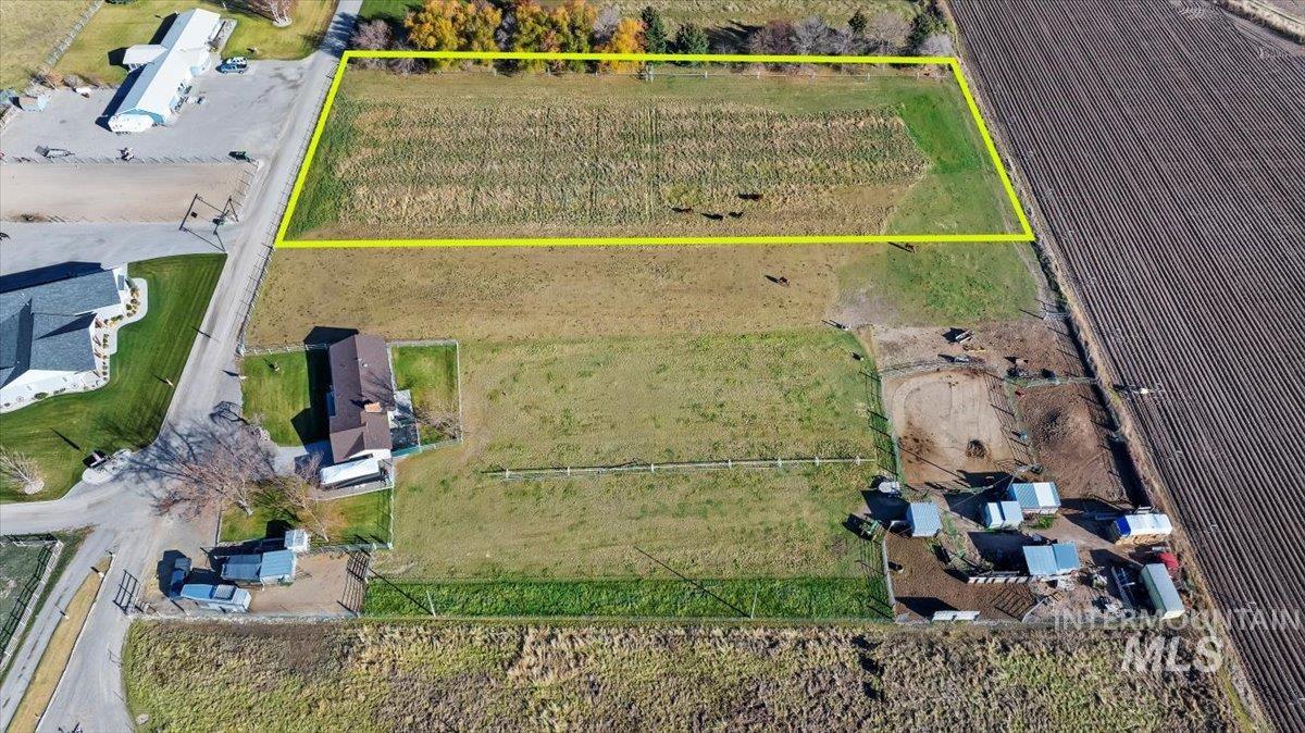 Aerial view of sparsely populated area featuring rows of crops and property boundaries highlighted