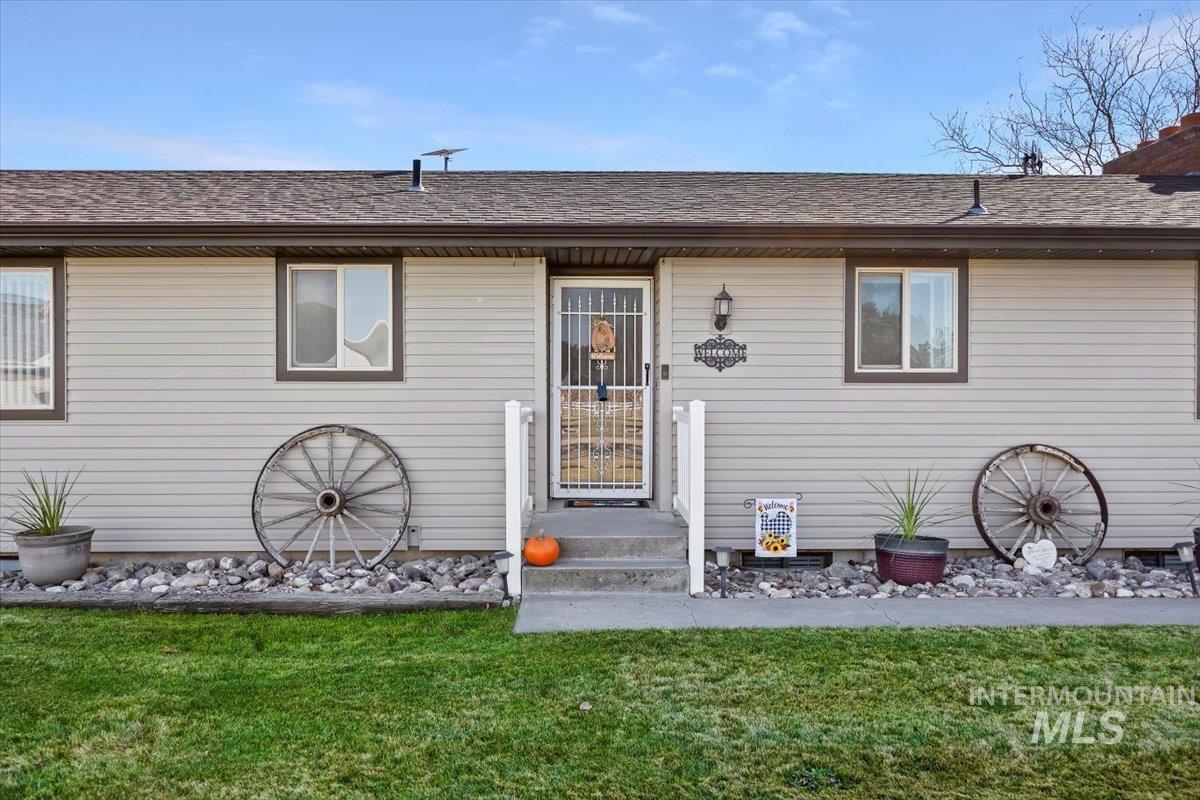 View of front of property featuring a front yard and a shingled roof