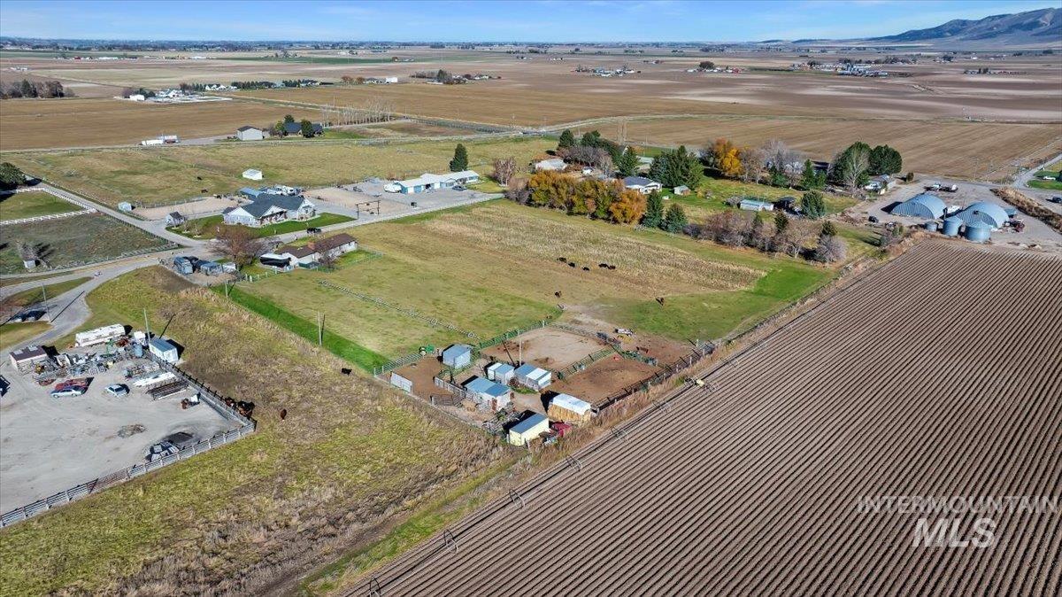 Aerial view of property and surrounding area featuring rural landscape