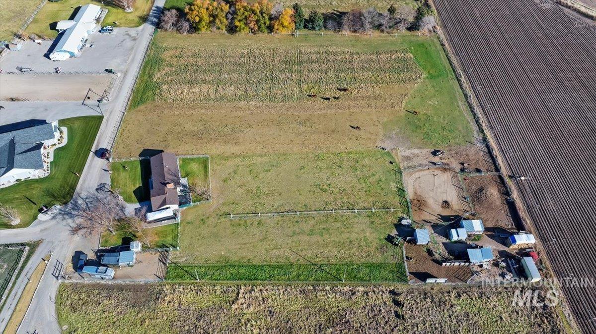 Aerial view of property's location featuring rows of crops and rural landscape