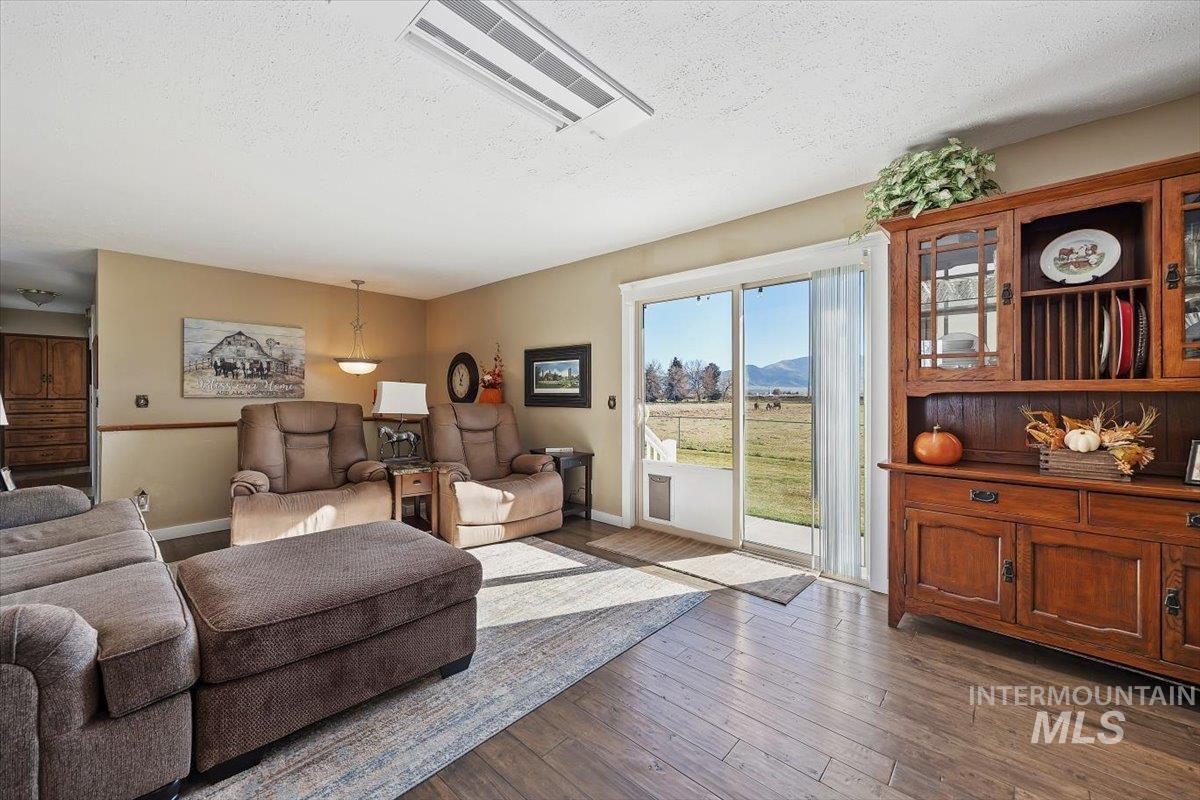Living area featuring a textured ceiling, hardwood / wood-style flooring, and a mountain view