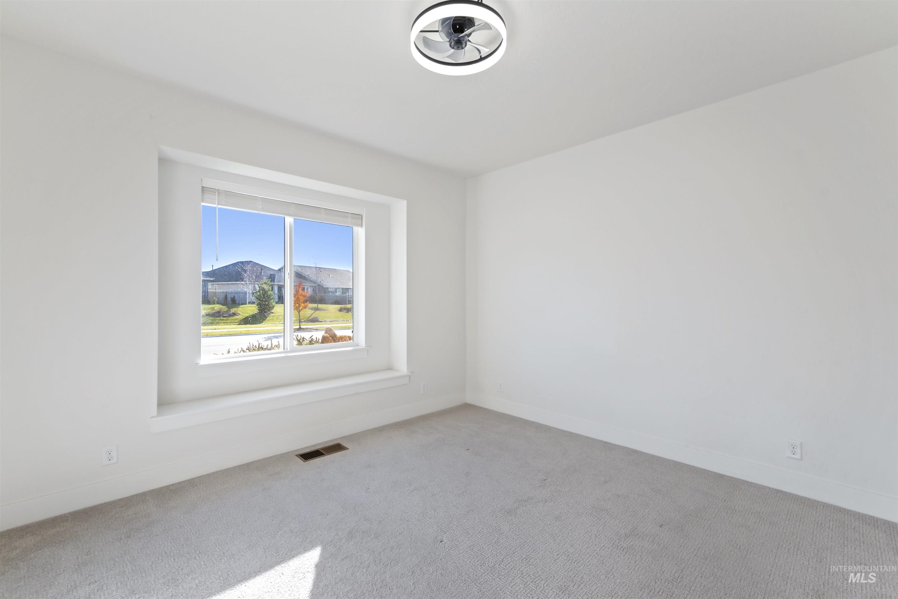 Empty room with carpet floors and baseboards