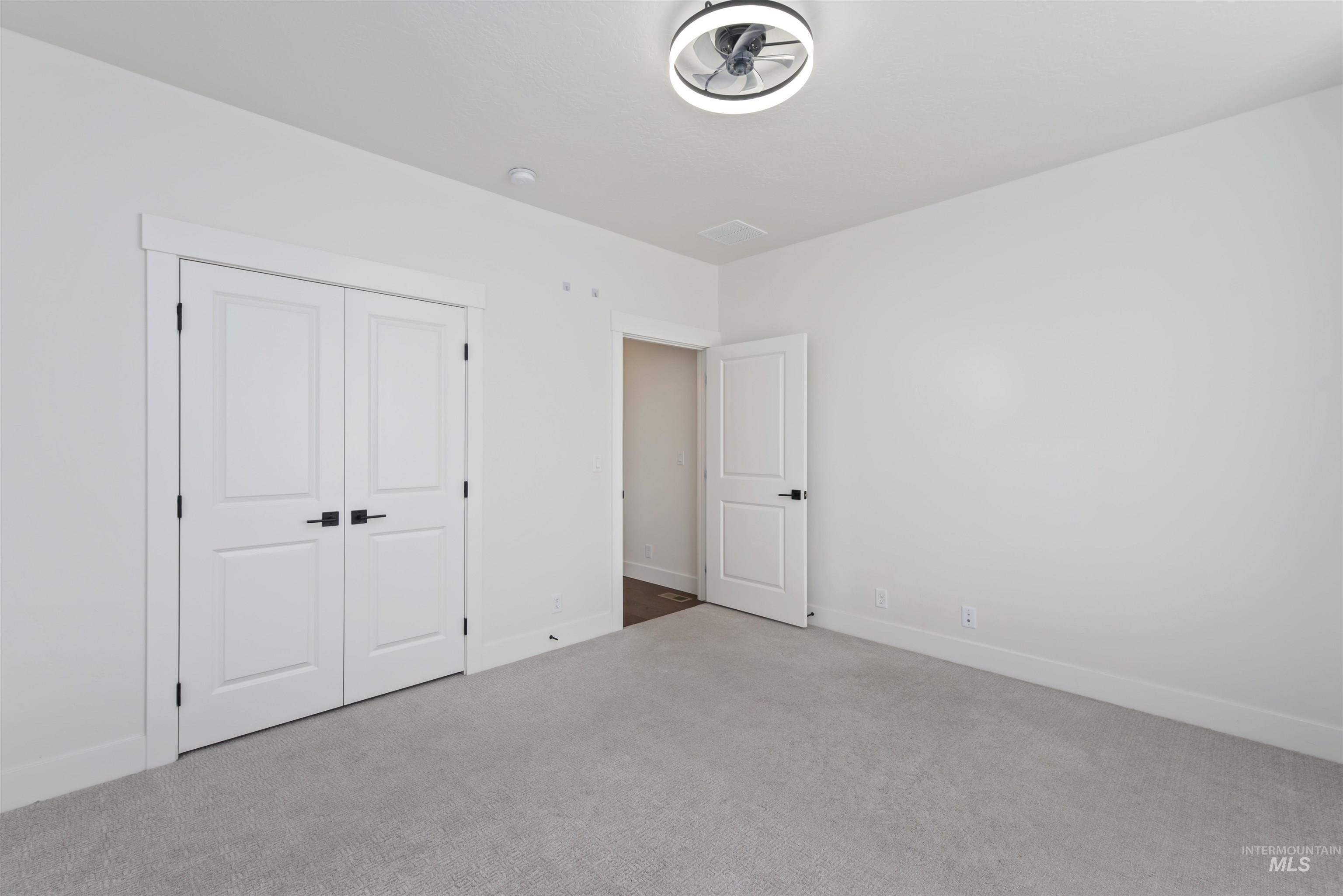 Unfurnished bedroom featuring carpet flooring and a closet