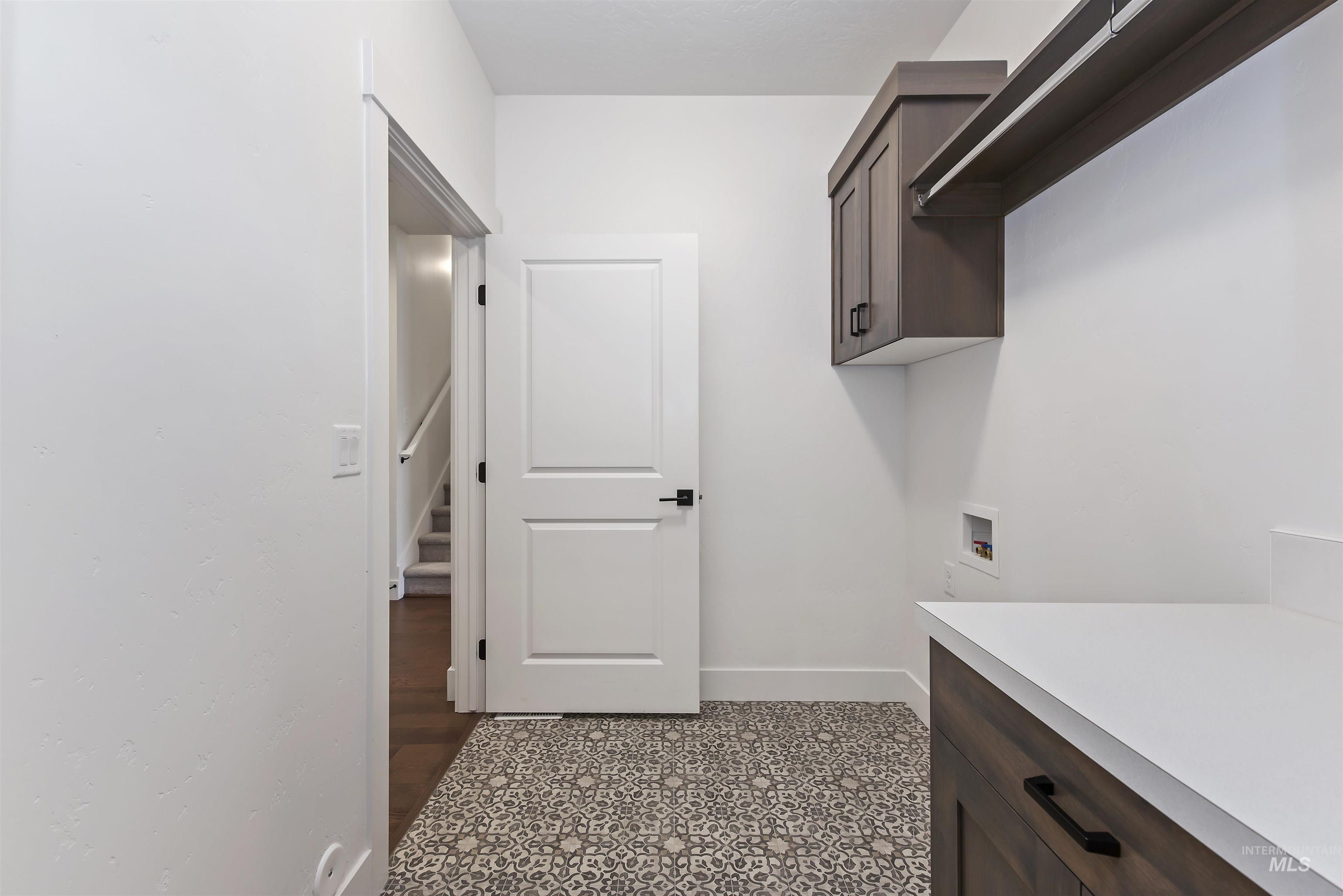 Laundry area with washer hookup and cabinet space