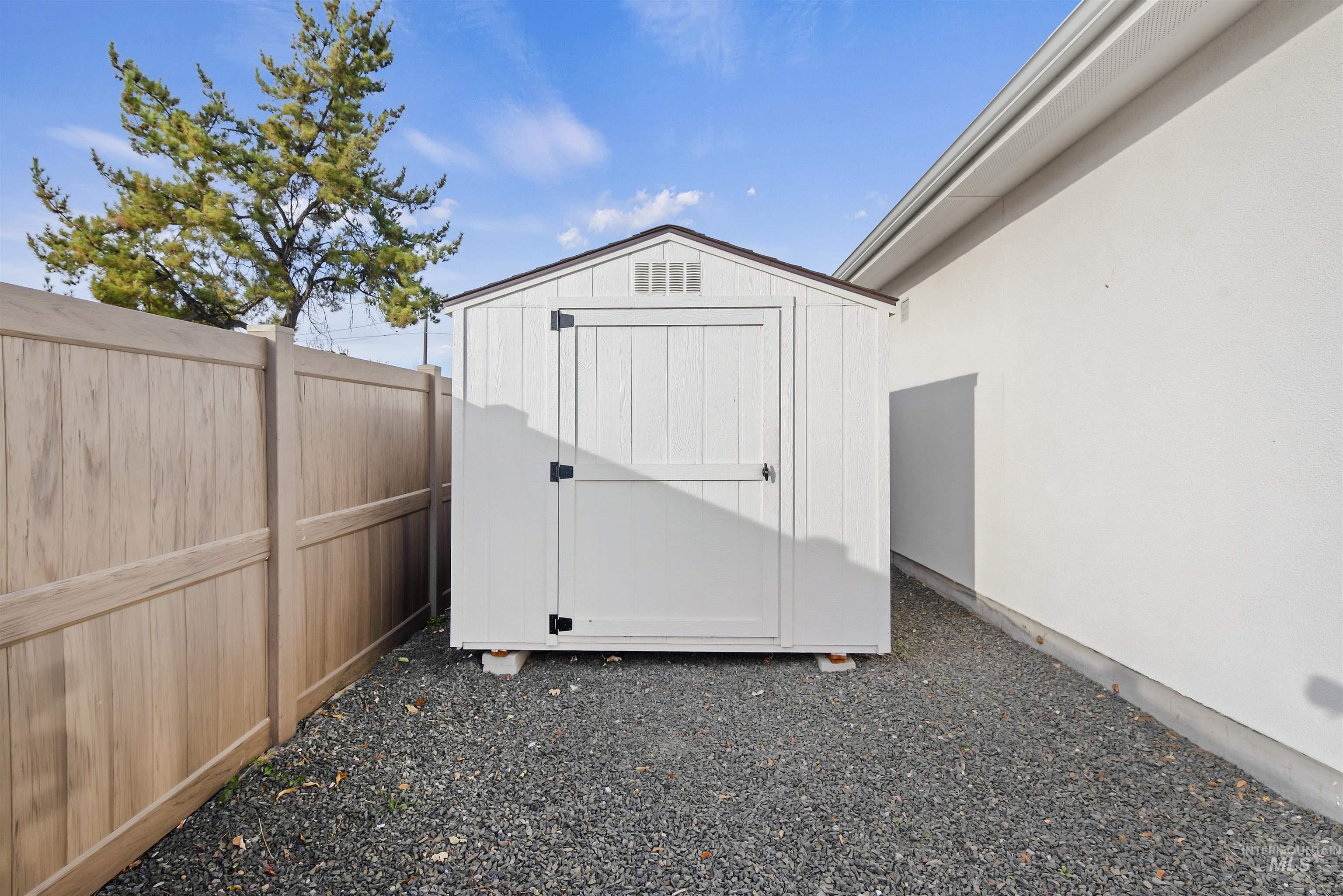 View of shed with a fenced backyard