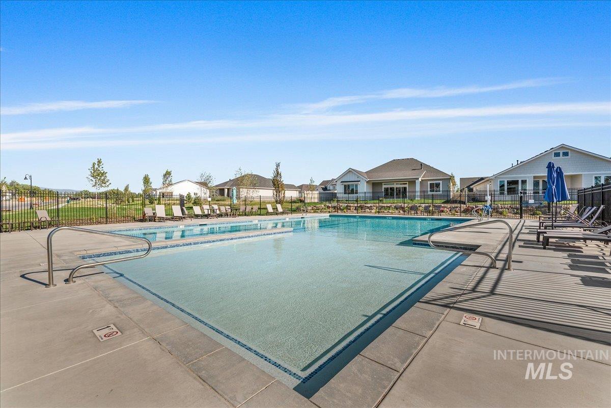 Community pool with a residential view and a patio
