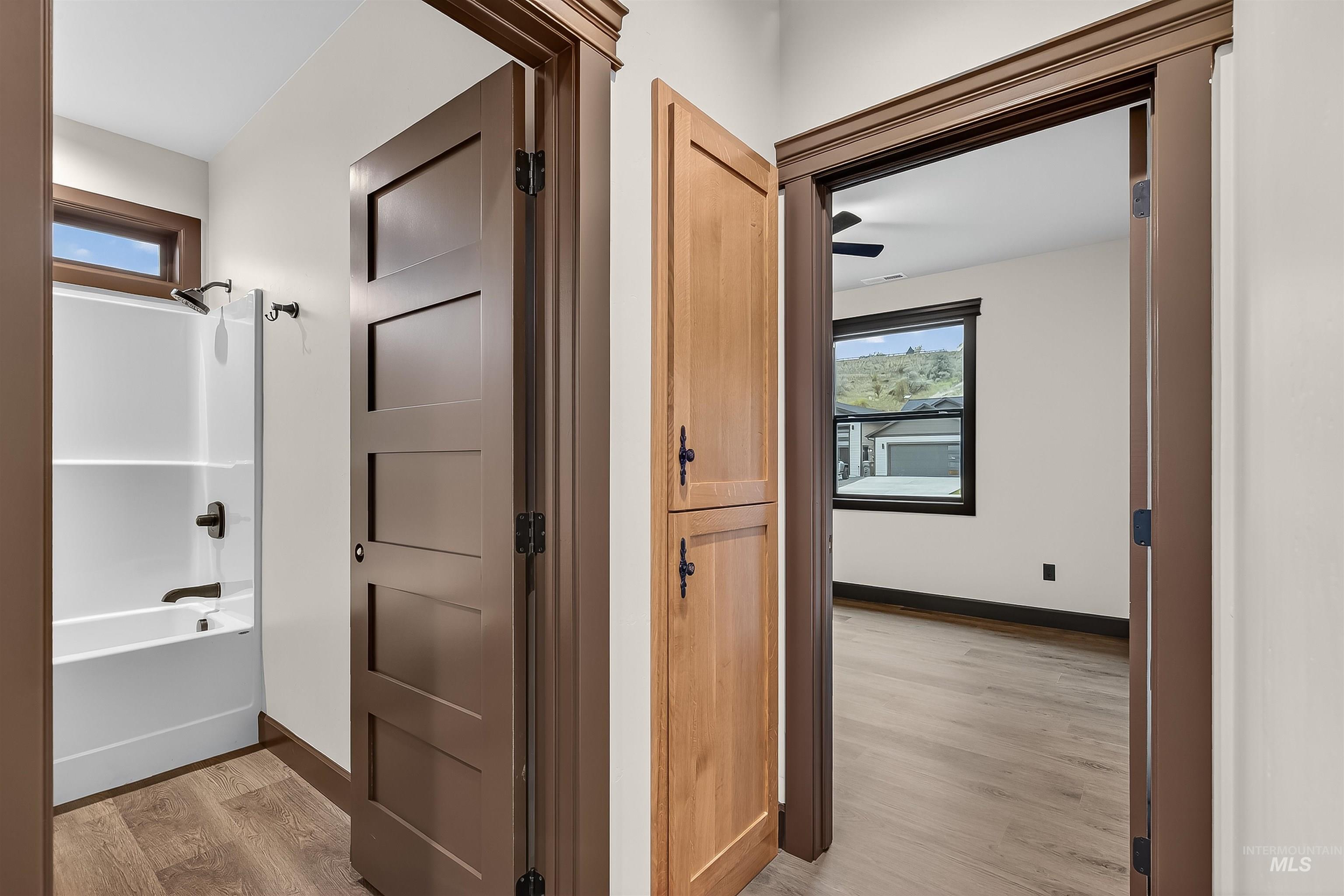 Hallway featuring healthy amount of natural light and light wood finished floors