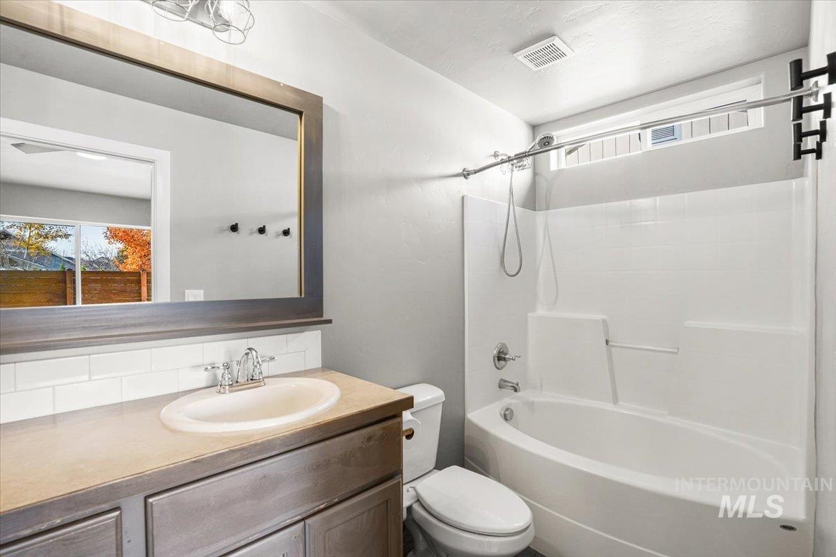 Bathroom featuring vanity and shower / bath combination