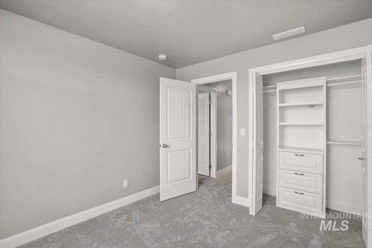 Unfurnished bedroom featuring carpet floors and a closet