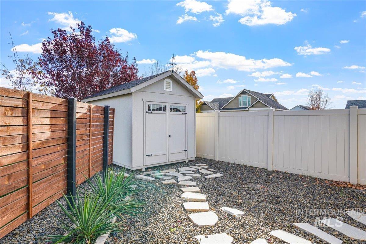 Fenced backyard with a storage unit