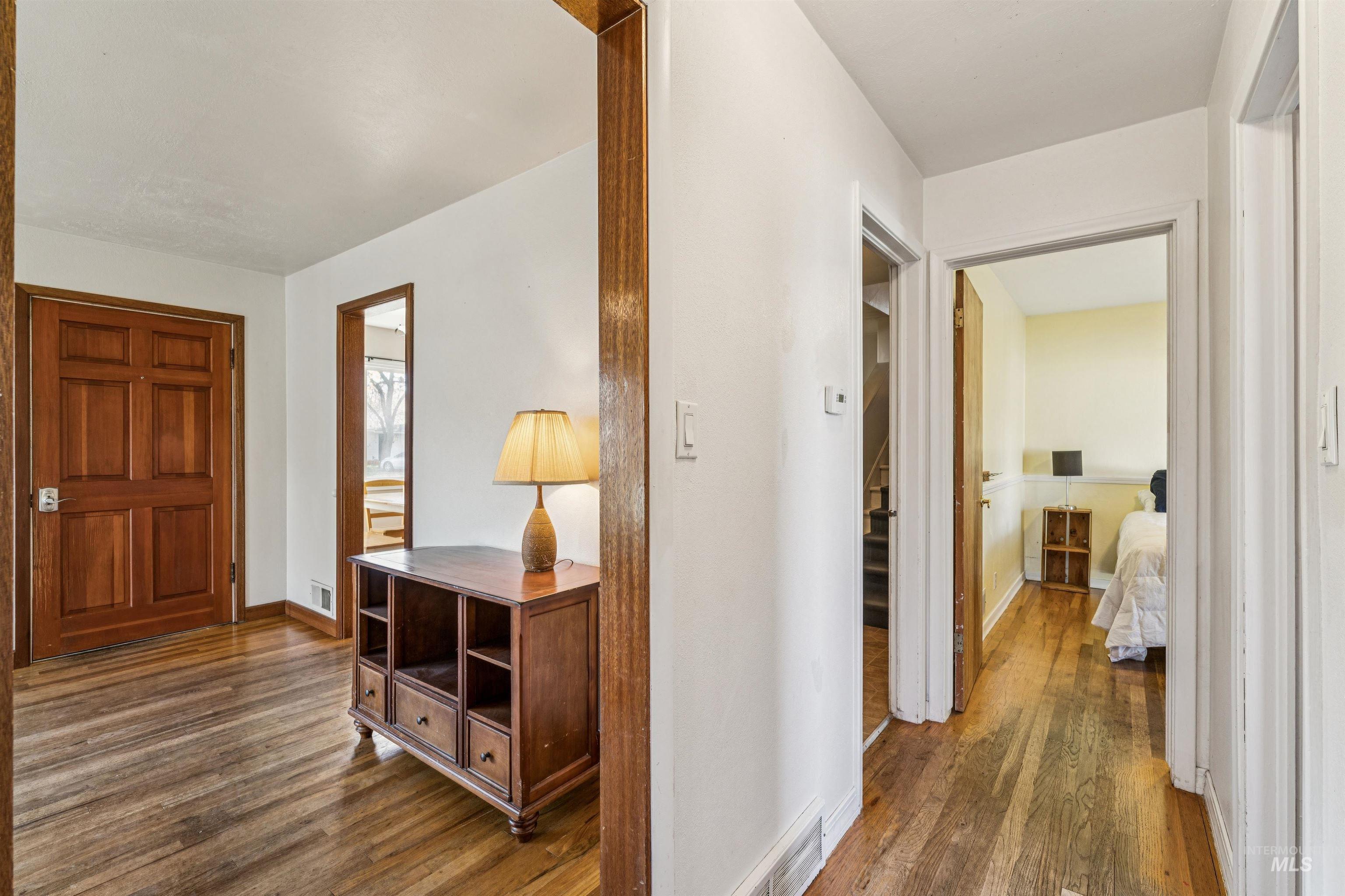 Hallway with dark wood finished floors