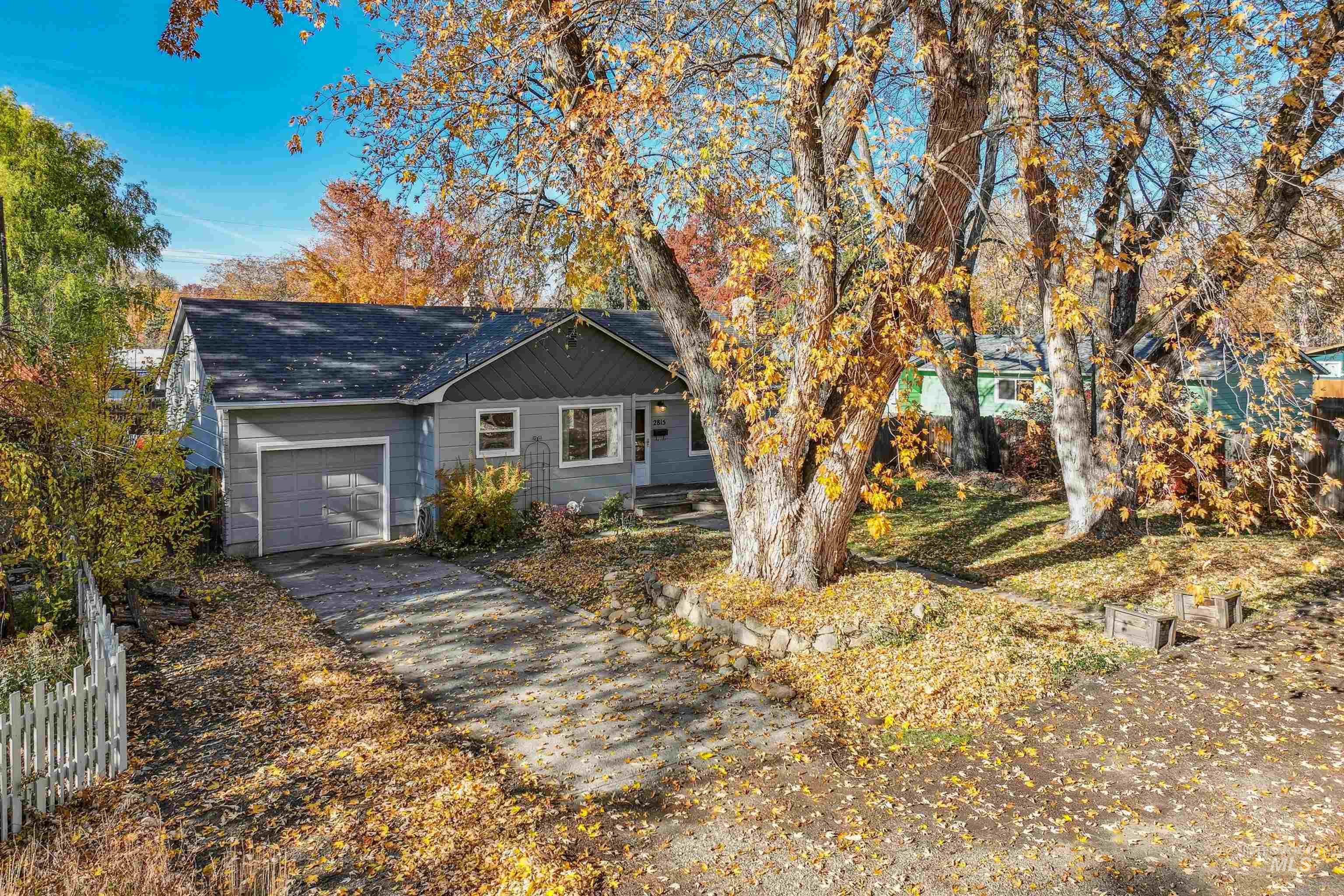 View of front of home with a garage and driveway