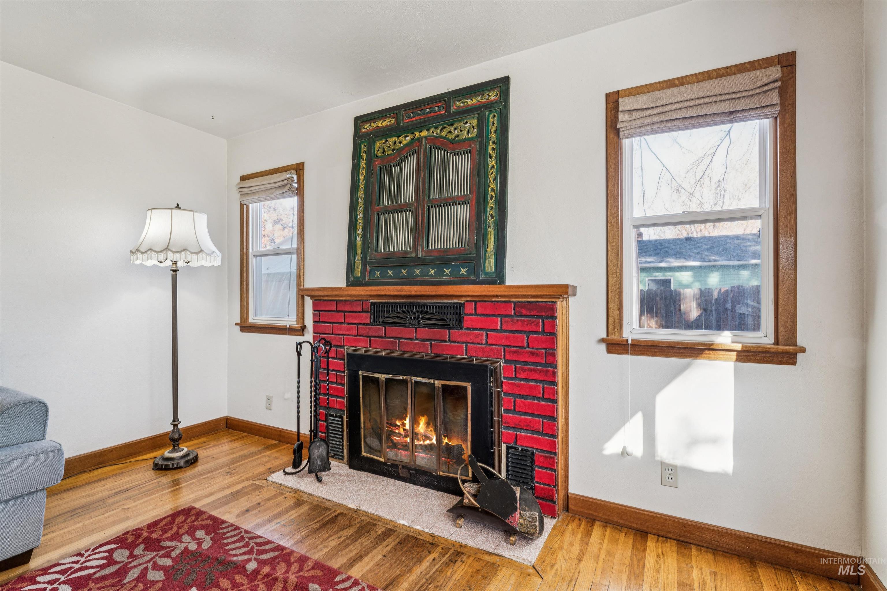 Living area featuring wood finished floors and a fireplace