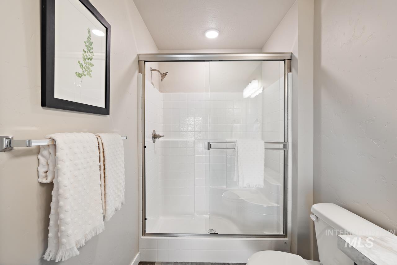Full bathroom with a shower stall