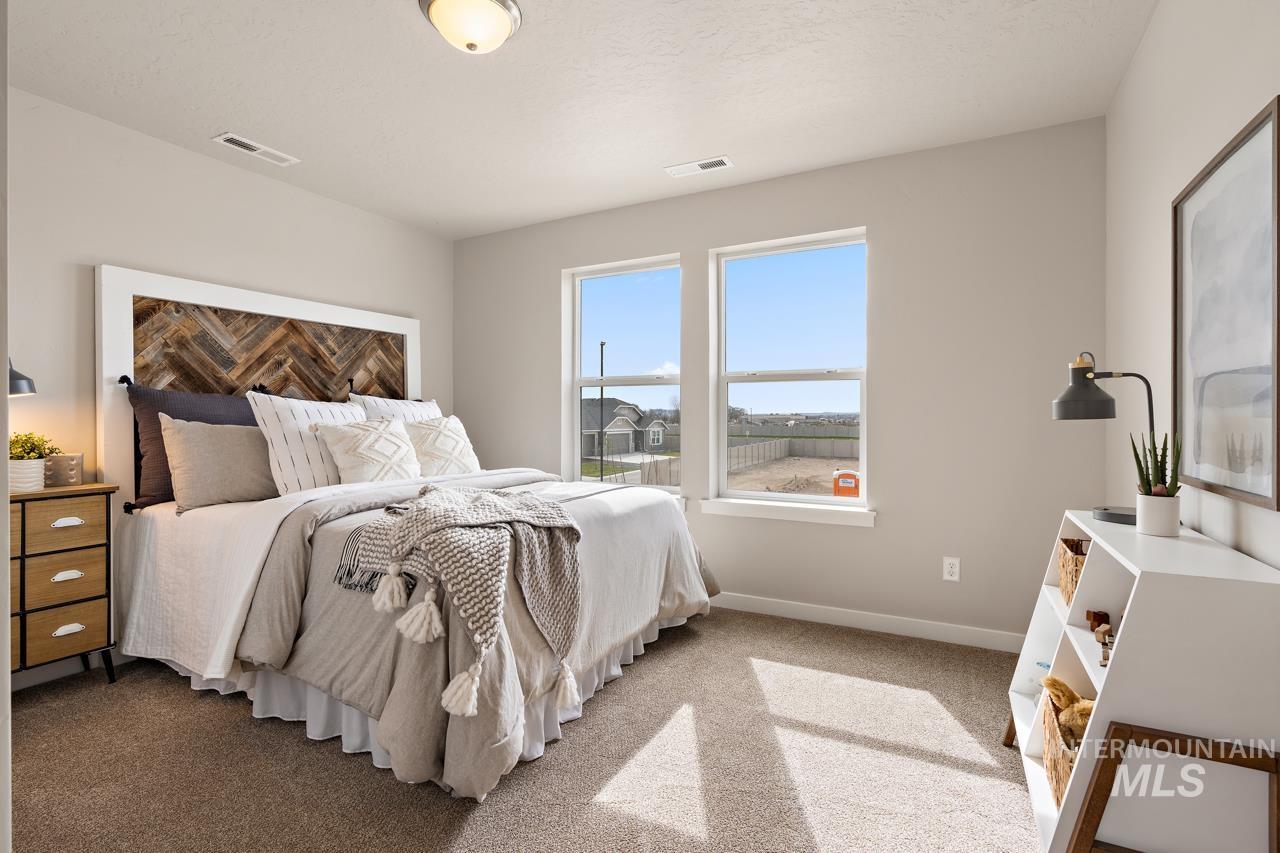Carpeted bedroom featuring baseboards