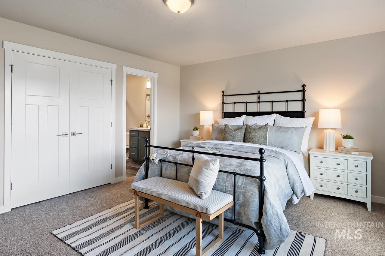 Bedroom with carpet flooring, connected bathroom, and a closet