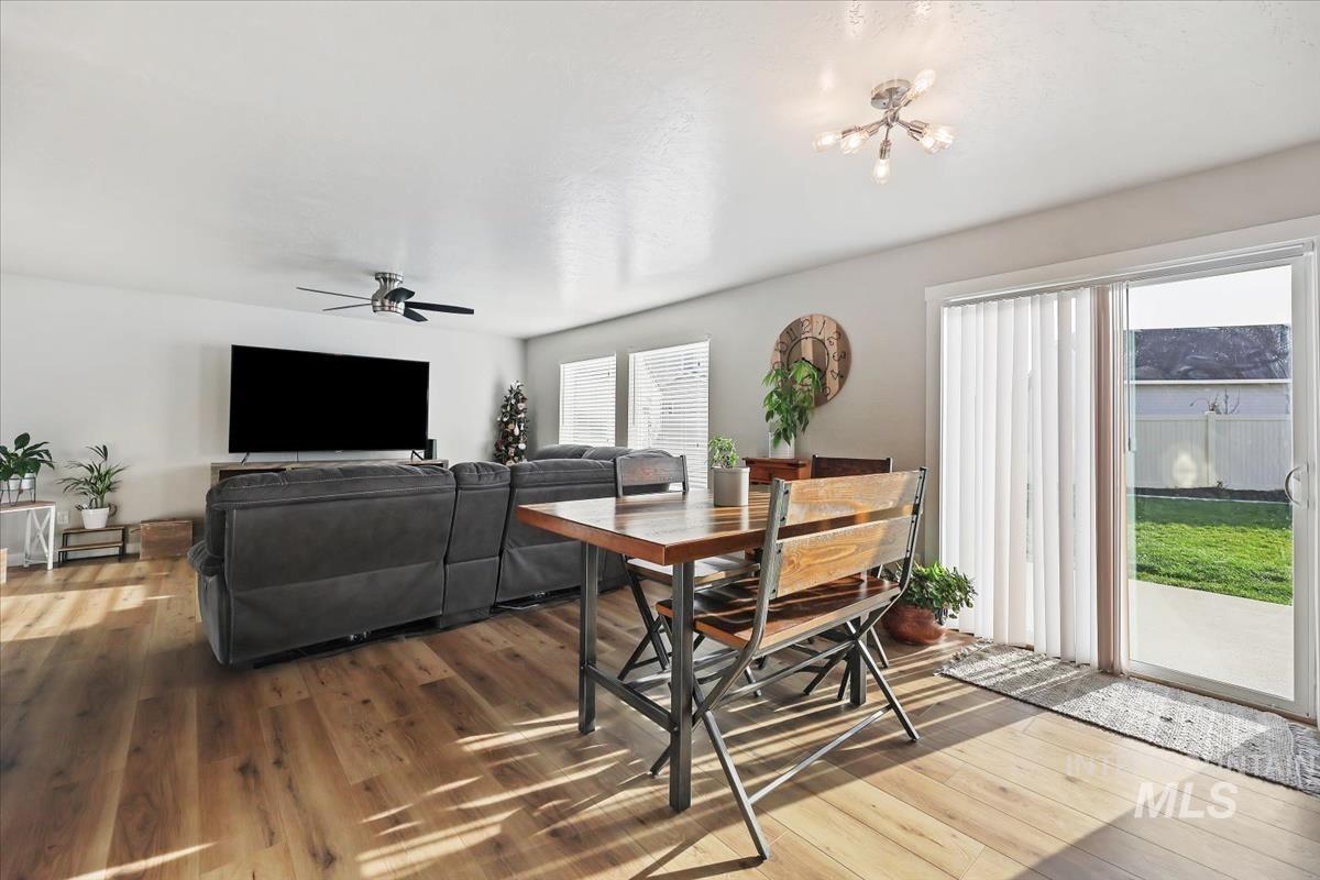 Dining space with wood finished floors and ceiling fan