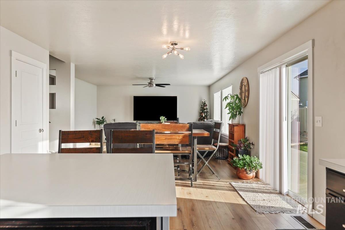 Living room with light wood-type flooring and ceiling fan
