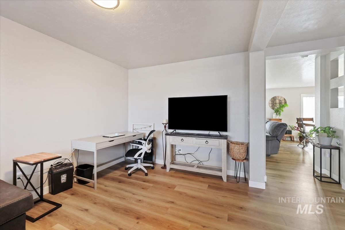 Office area with light wood finished floors and baseboards