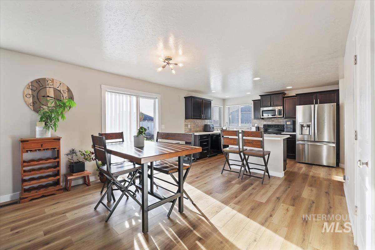Dining space with light wood-style flooring and recessed lighting