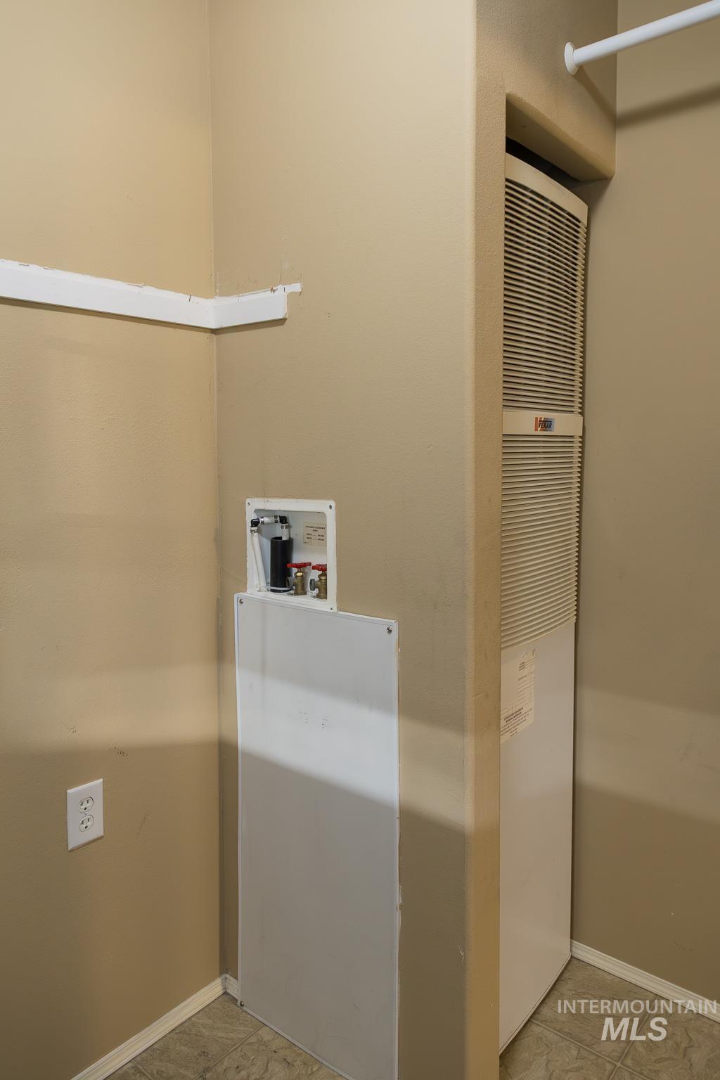 Laundry room with a heating unit