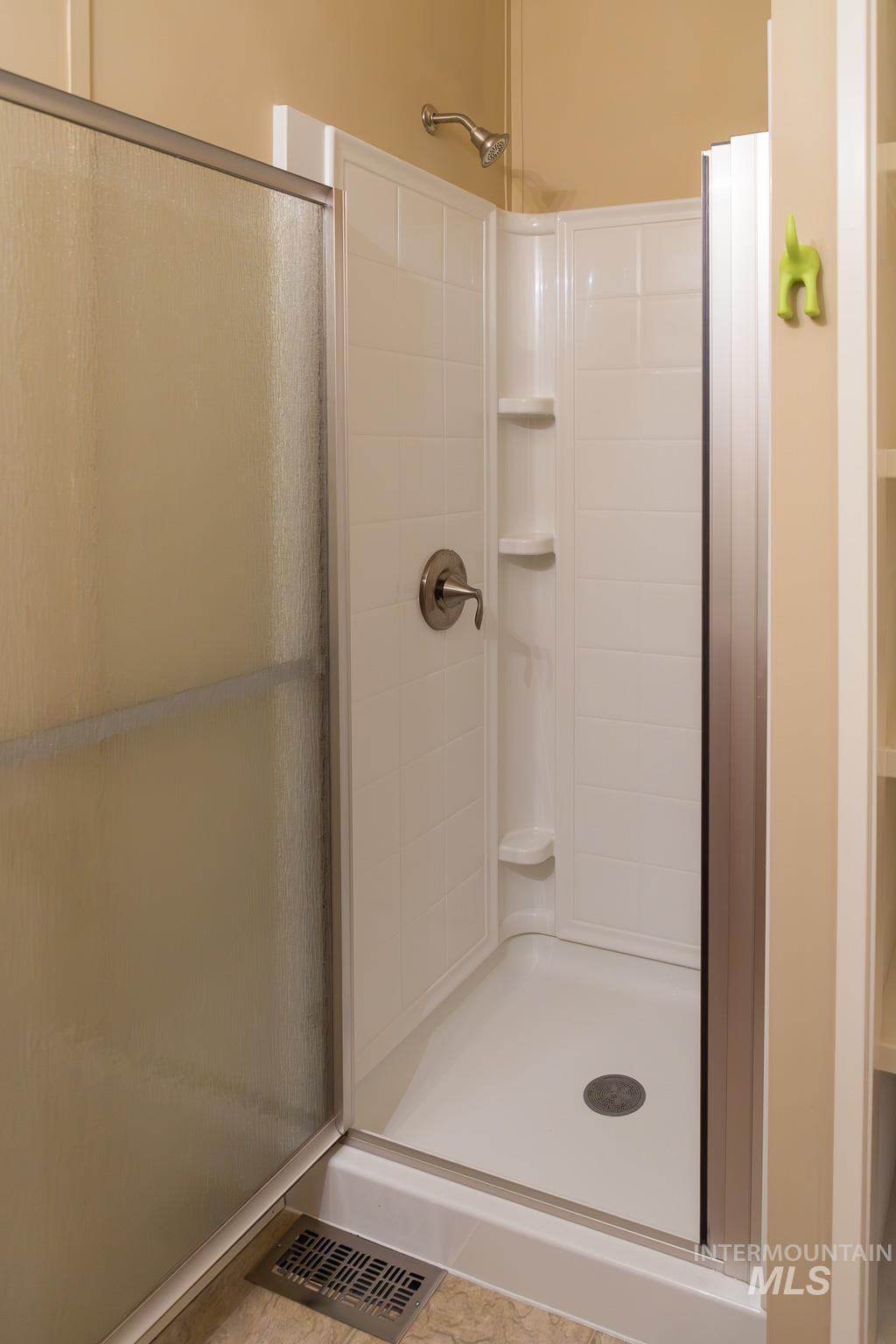 Full bath featuring a shower stall